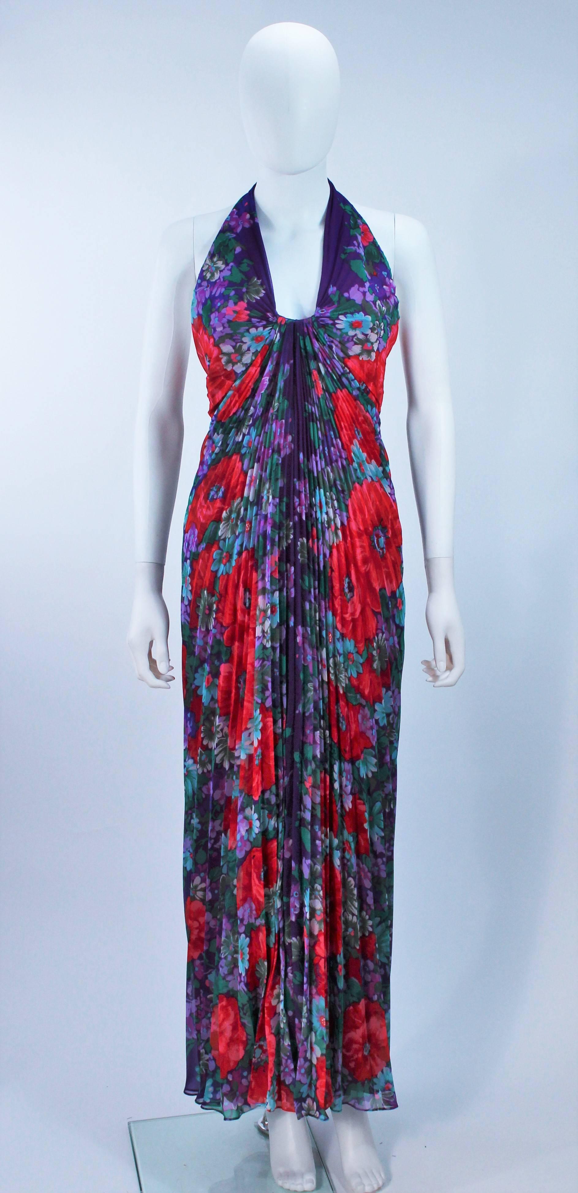  This Travilla  gown is composed of a purple pleated floral print fabric. There is a center back zipper closure. In excellent vintage condition. 

  **Please cross-reference measurements for personal accuracy. Size in description box is an