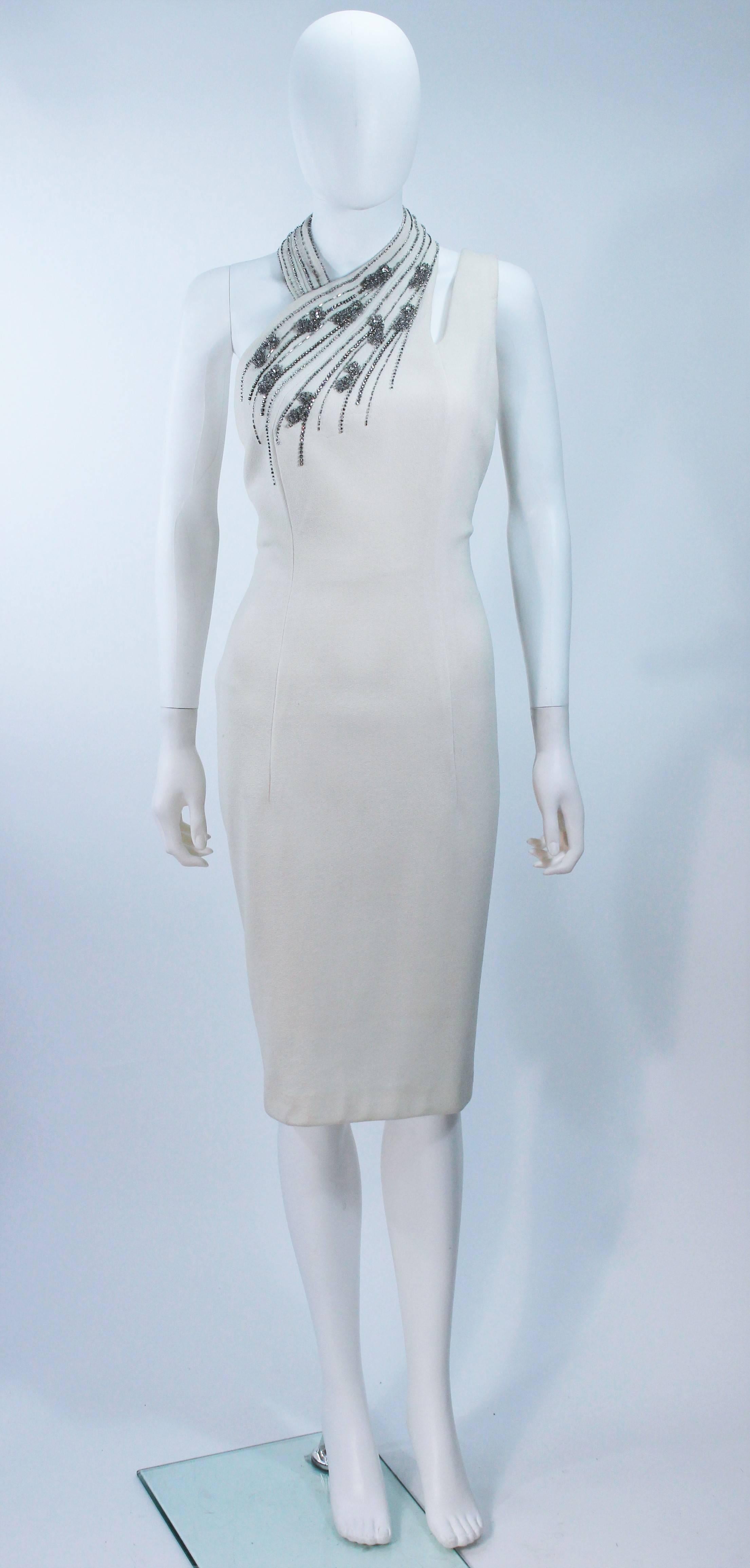  This vintage Sydney North cocktail dress is composed of a white crepe and features an asymmetrical halter design. There is a center back zipper closure. In excellent vintage condition. 

**Please cross-reference measurements for personal