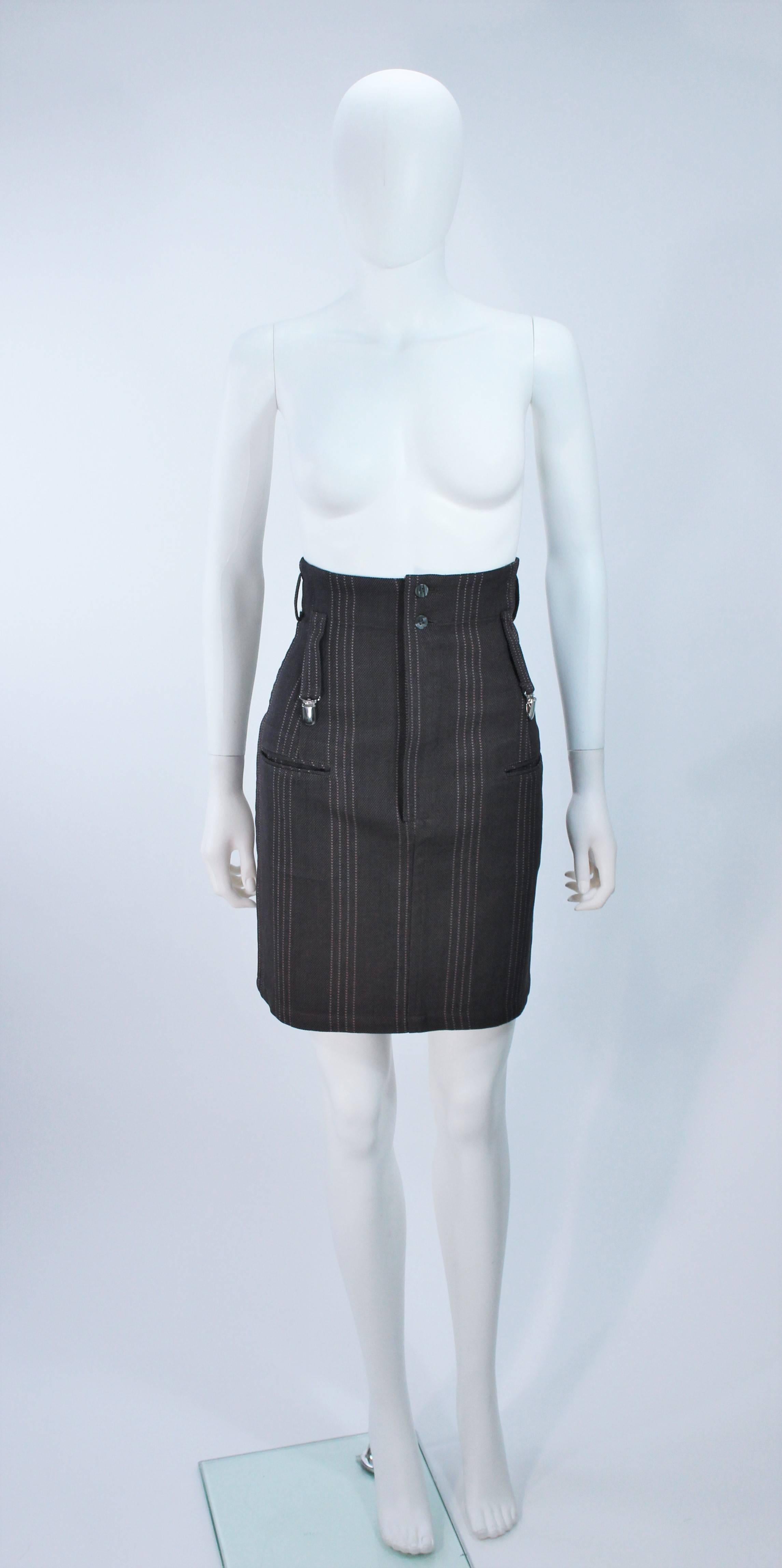  This Yohji Yamamoto skirt is composed of pinstripe wool featuring a suspender detail. There is a center front zipper closure. In excellent vintage condition. 

  **Please cross-reference measurements for personal accuracy.

Measures