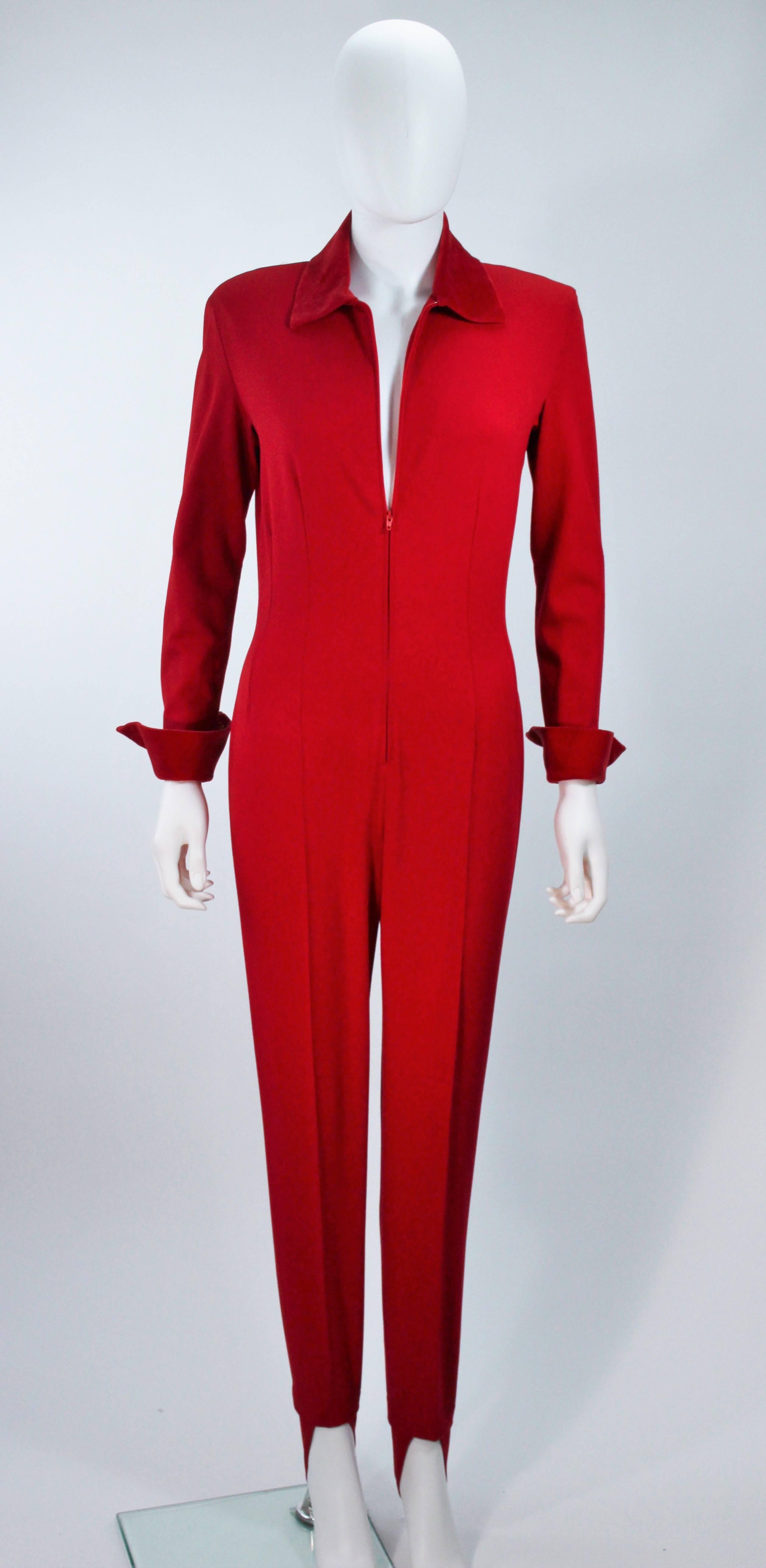  This Moschino d pantsuit is composed of a stretch red wool with velvet trim. Features a center front zipper closure as well as zippered sleeves, and stirrup foot details. In excellent vintage condition. 

  **Please cross-reference measurements