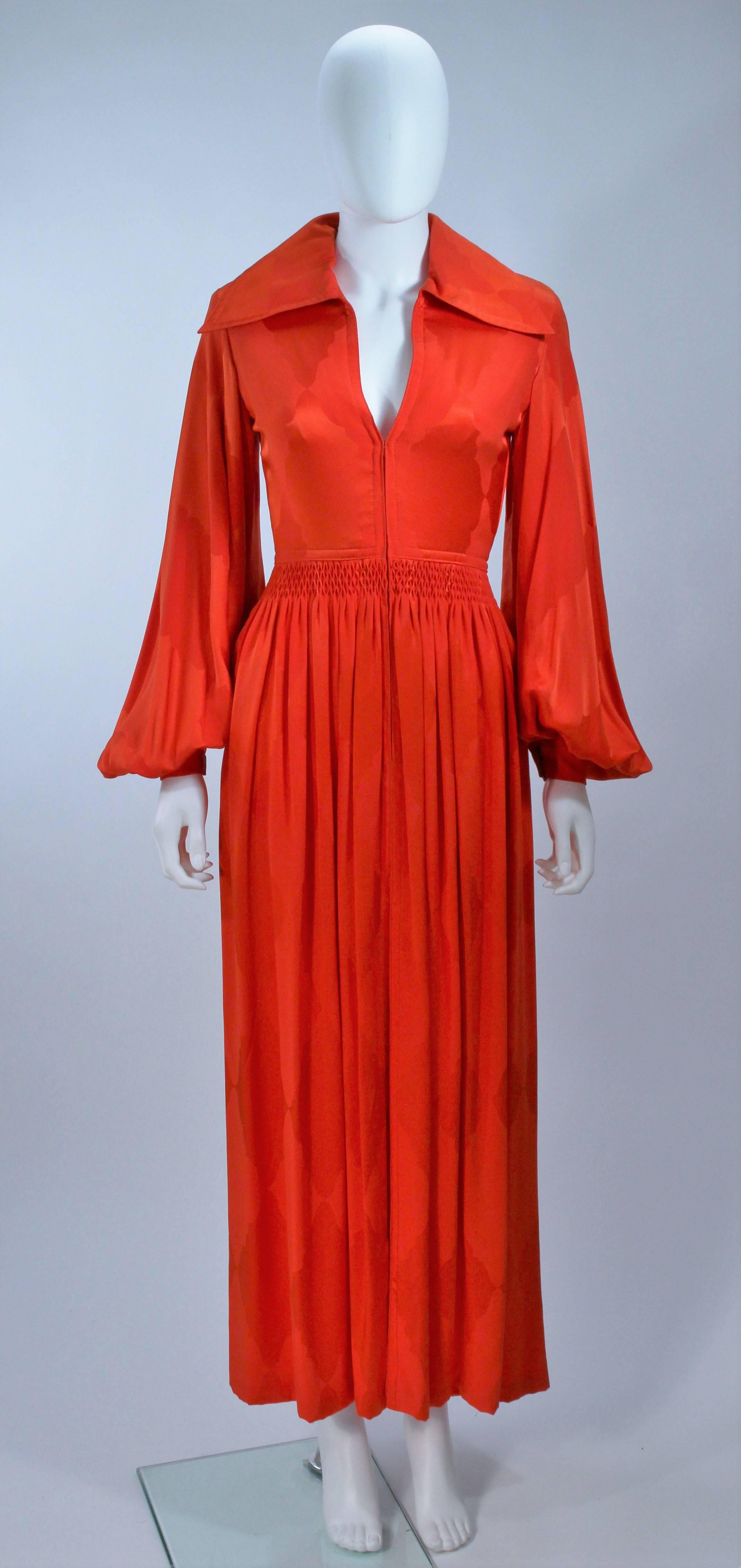  This Galanos  gown is composed of  bright orange silk and features billow sleeves, with a tacked detail waist. There is a center front zipper closure. In excellent vintage condition. 

  **Please cross-reference measurements for personal