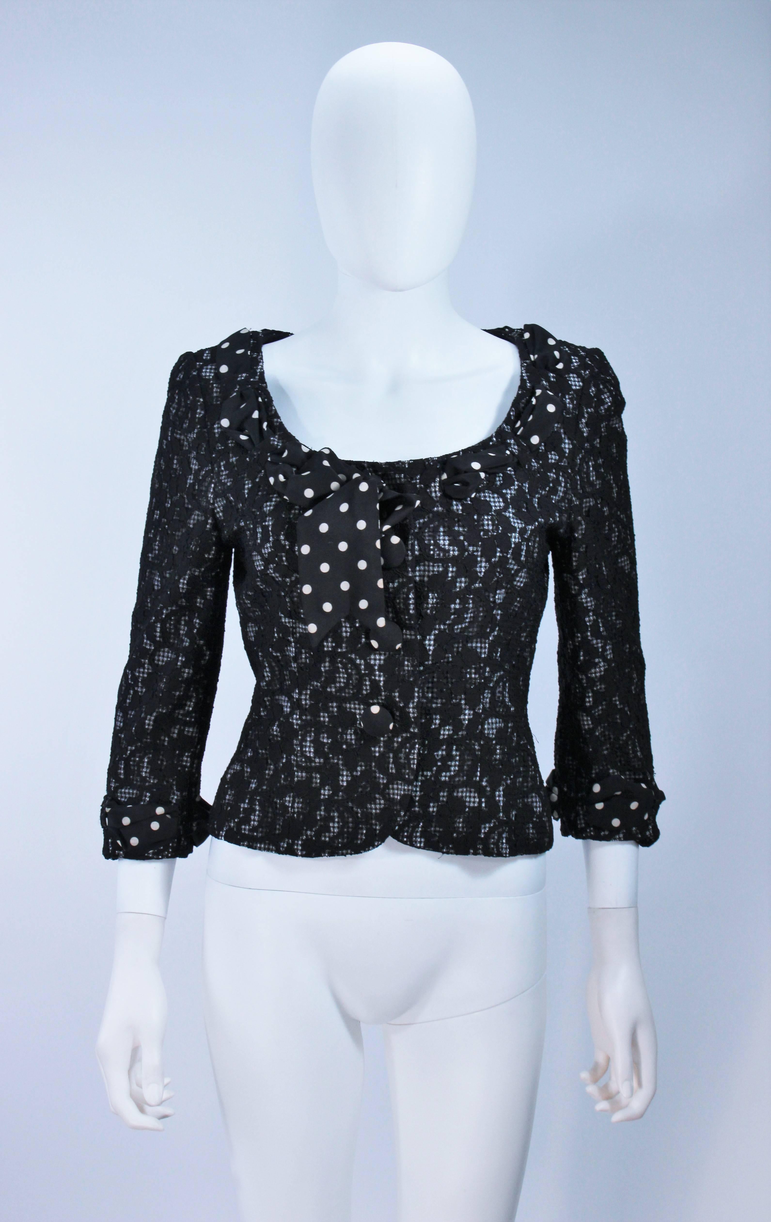  This Moschino  jacket is composed of a mixed combination of fabric patterns, there is a gingham base with a lace overlay and a silk polka dot scarf detail. There are center front closures. In great condition. 

Measures (Approximately)
Length: