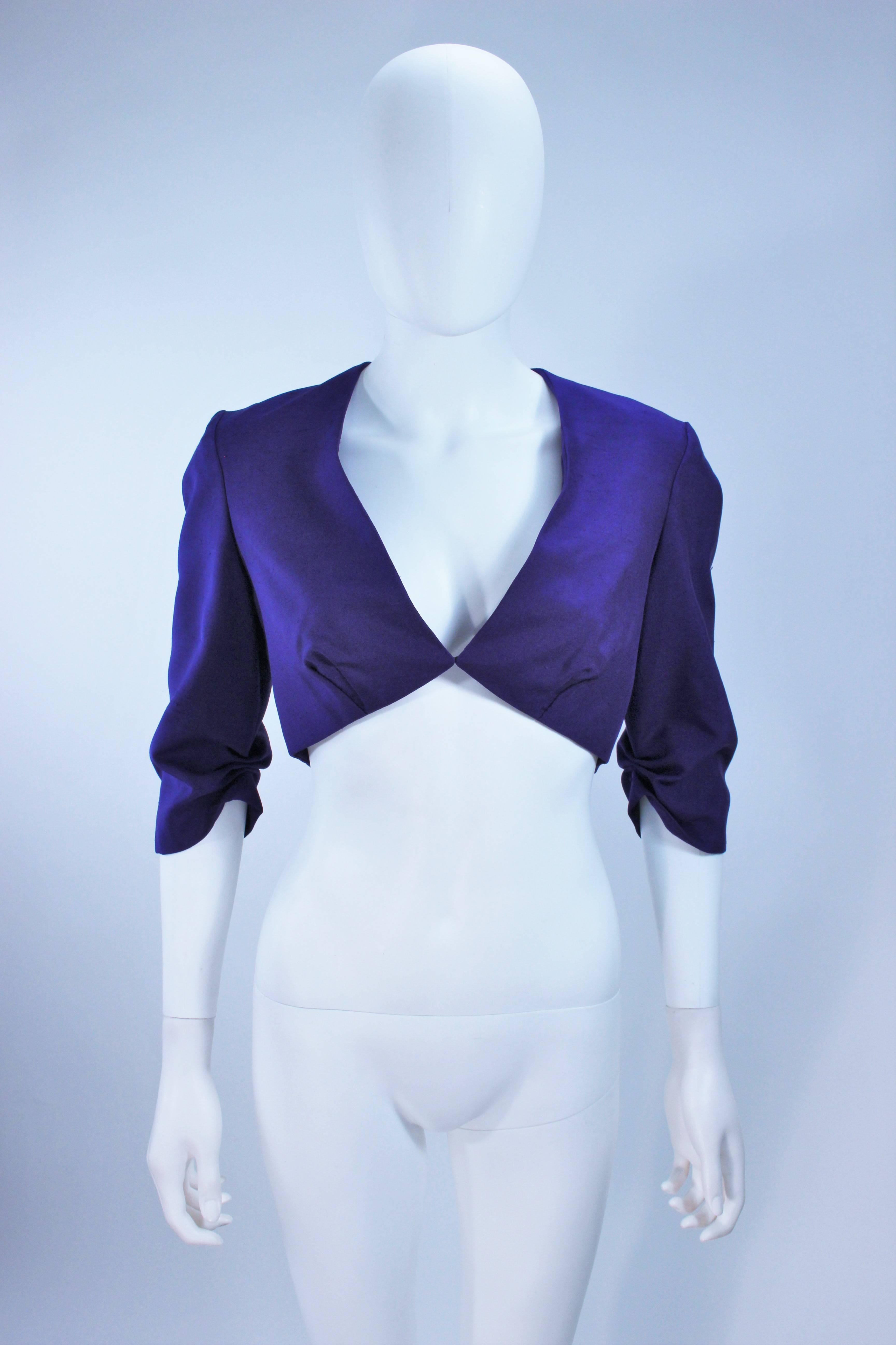 This Elizabeth Mason Couture jacket  is composed of a fine purple silk and features a center front hook & eye closure with a darted design. Made in Beverly Hills. 

This is a couture custom order. Please allow for a 60 day lead time from