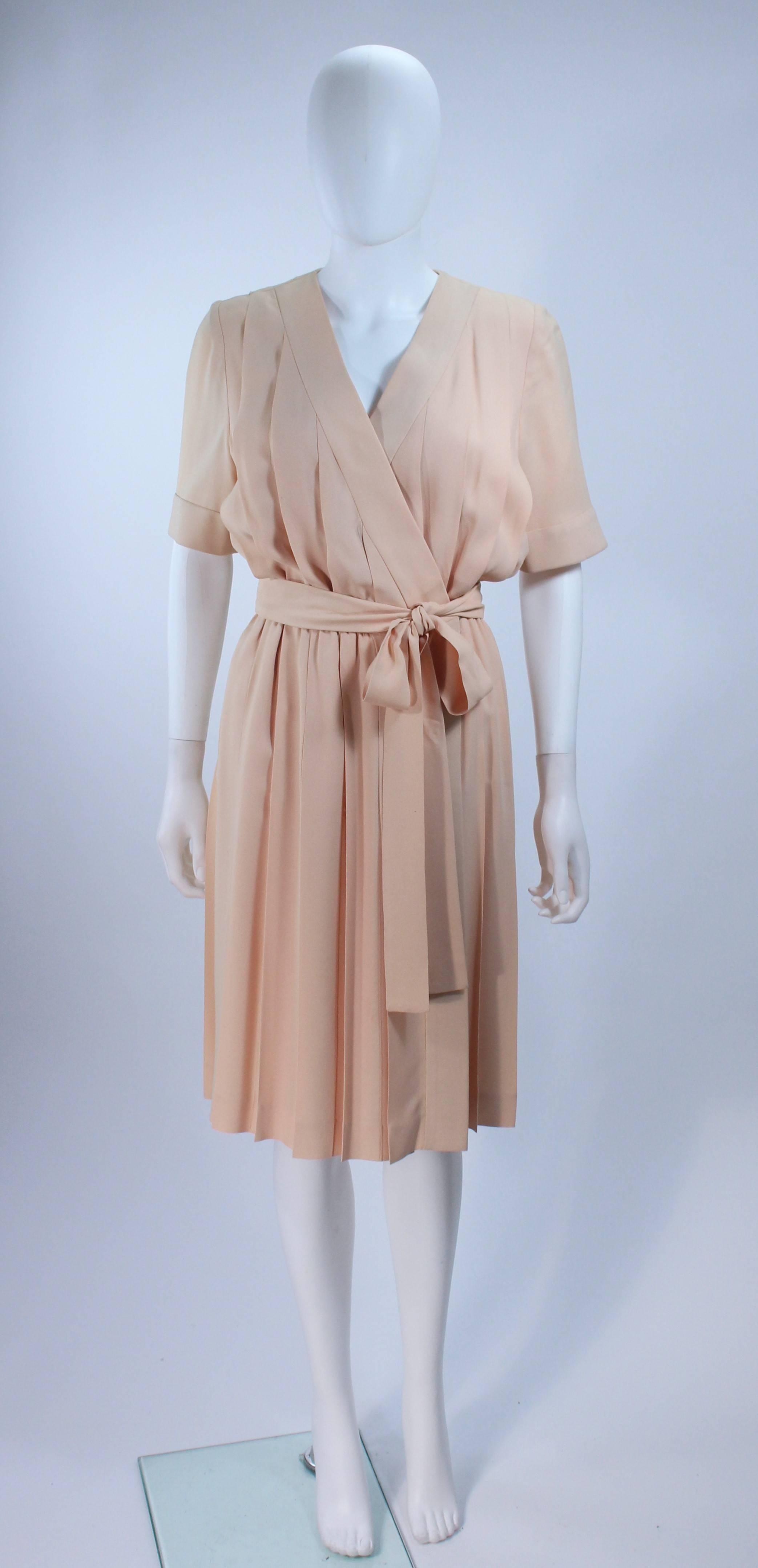  This Givenchy Couture dress is composed of a off white-cream silk with chiffon lining. The wrap ostyle features snap closures at the center front. Pleated design. In great vintage condition. 

  **Please cross-reference measurements for personal