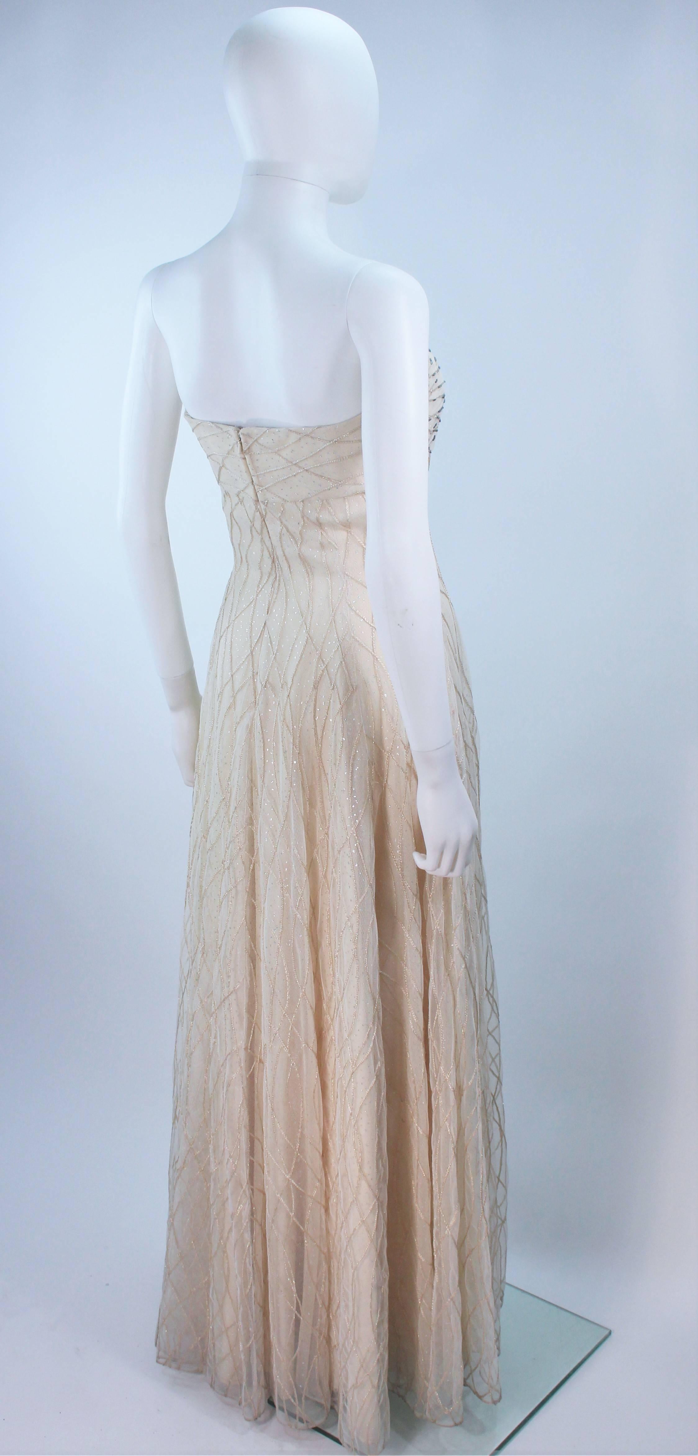  This Victor Costa  gown is composed of an off white layered mesh with iridescent cascading beaded applique. There is a center back zipper closure with interior boning and bra. In great vintage condition. 

  **Please cross-reference measurements