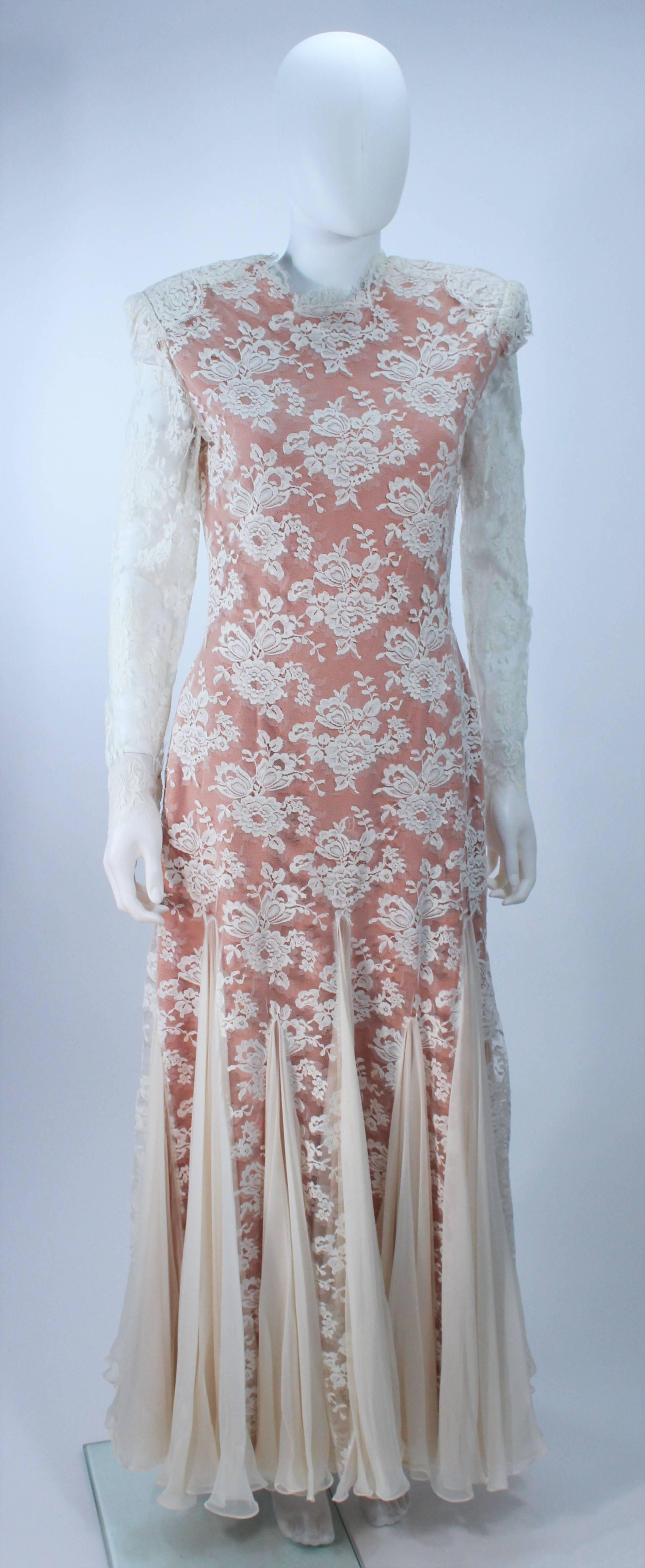  This Travilla design of an off white lace with a nude underlay. Features structured shoulders with pads and godet inserts at the hem. There is a zipper closure and scalloped edges throughout. In great vintage condition. 

  **Please