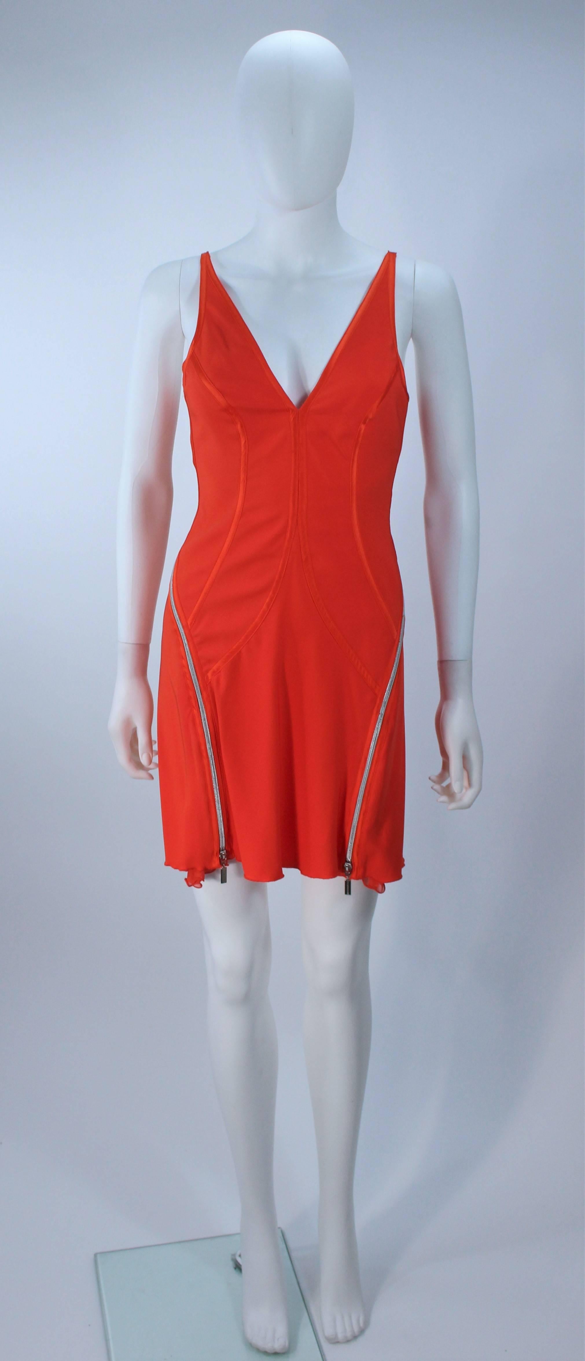  This Montana Blu  cocktail dress is composed of an orange stretch silk with zipper details which expose a chiffon accent. In great vintage condition. 

  **Please cross-reference measurements for personal accuracy. Size in description box is an