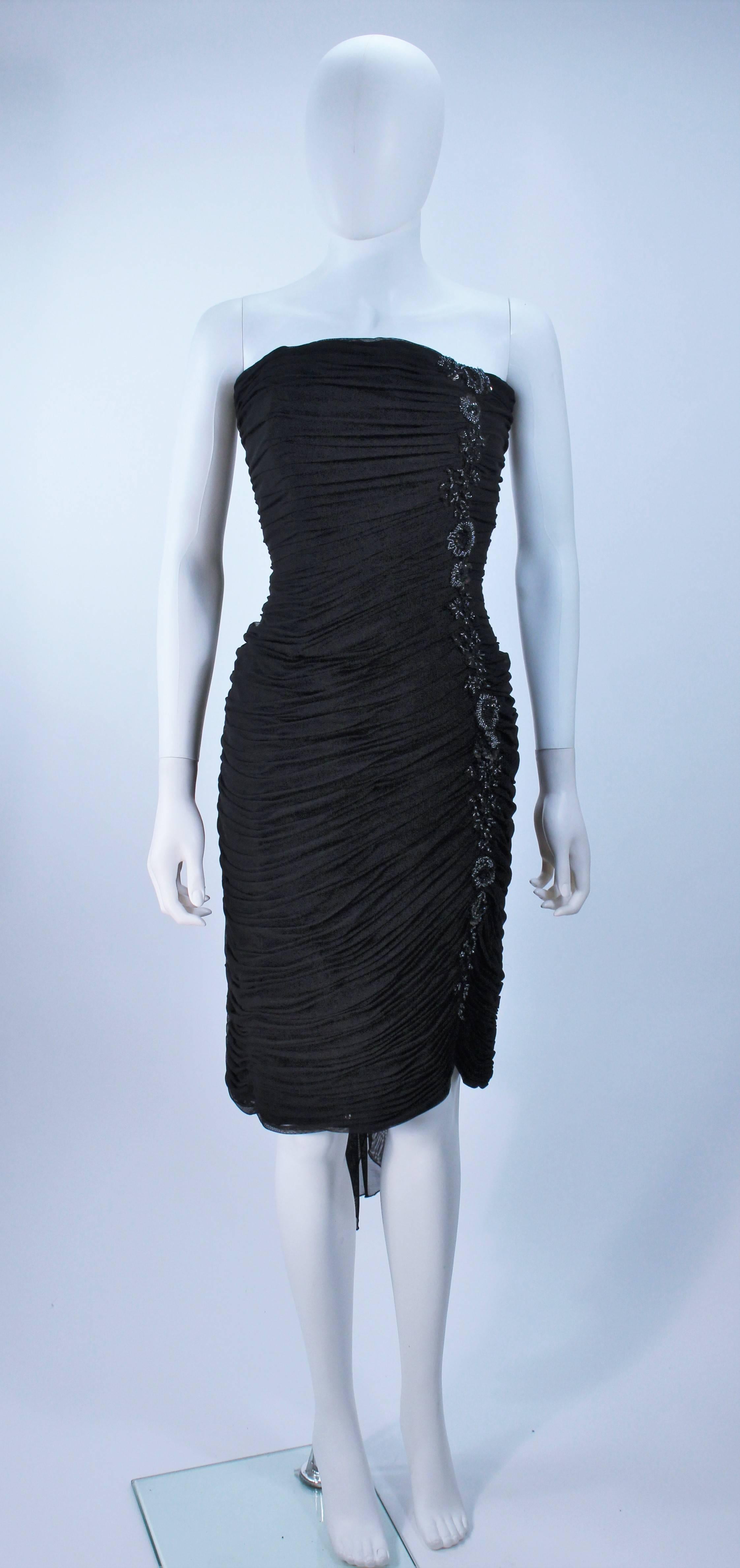  This Vicky Tiel cocktail dress is composed of a stretch sheer mesh with a beaded iridescent trim. There is a center back zipper closure, with boned detail. In great vintage condition. 

  **Please cross-reference measurements for personal