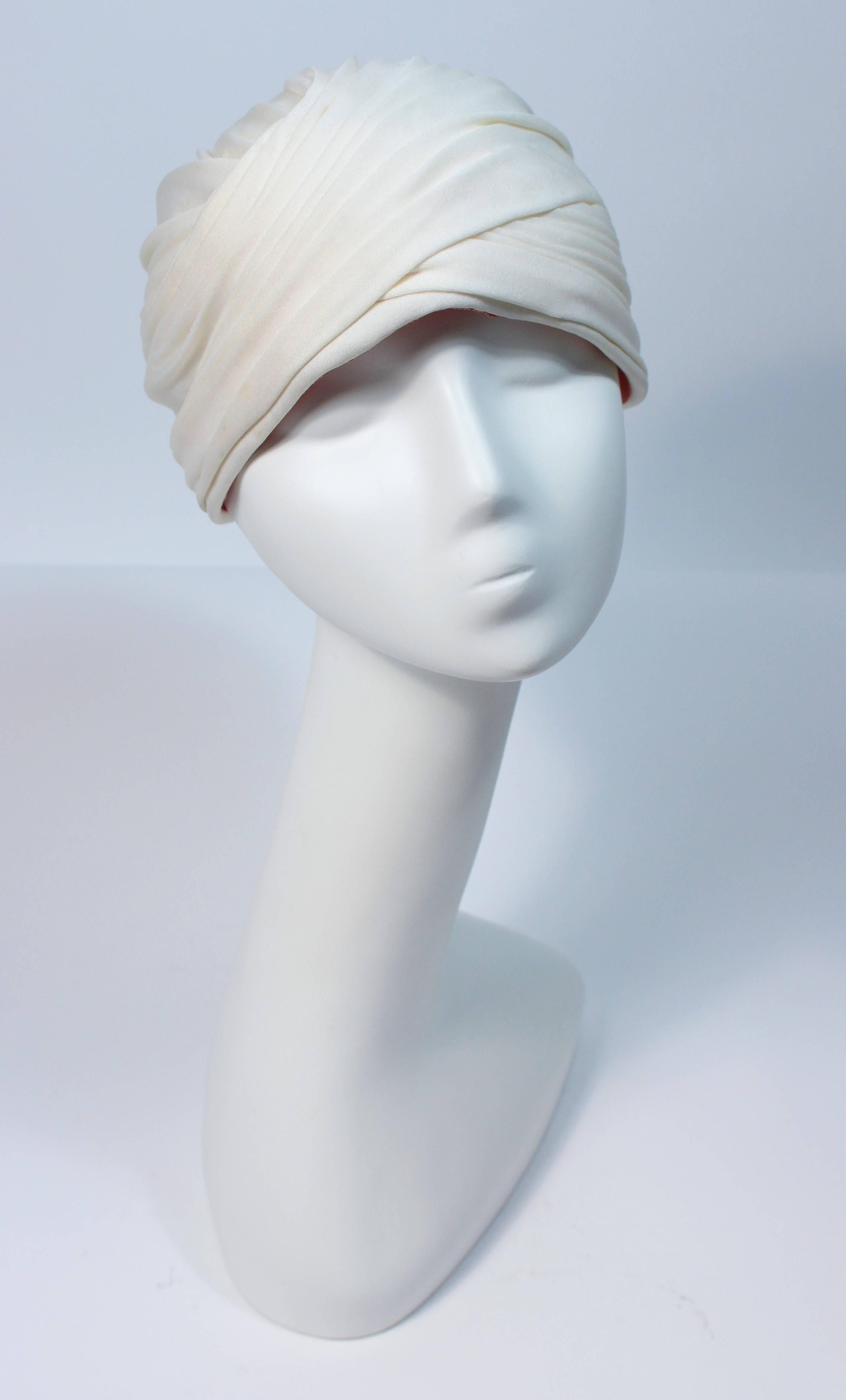  This Adolfo turban is composed of a ivory hue jersey. In great vintage condition, some slight color variation due to age, minimal. 

  **Please cross-reference measurements for personal accuracy. 

Measures (Approximately)
Depth: 5