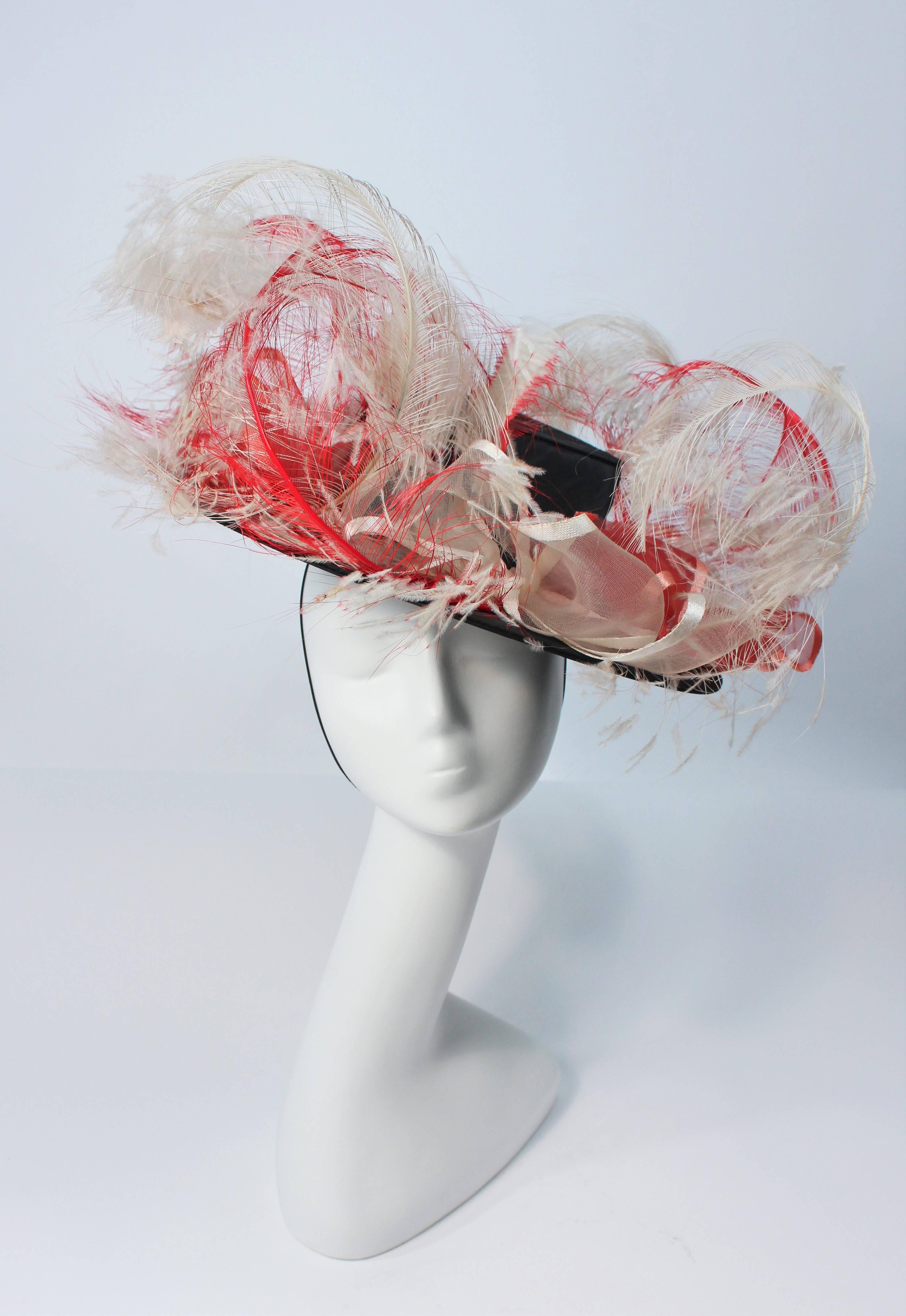 This Saks Fifth Ave. hat is composed of a black base with elastic piece for wear. Features white and red ostrich feathers. In excellent vintage condition. 

  **Please cross-reference measurements for personal accuracy. 

Measures