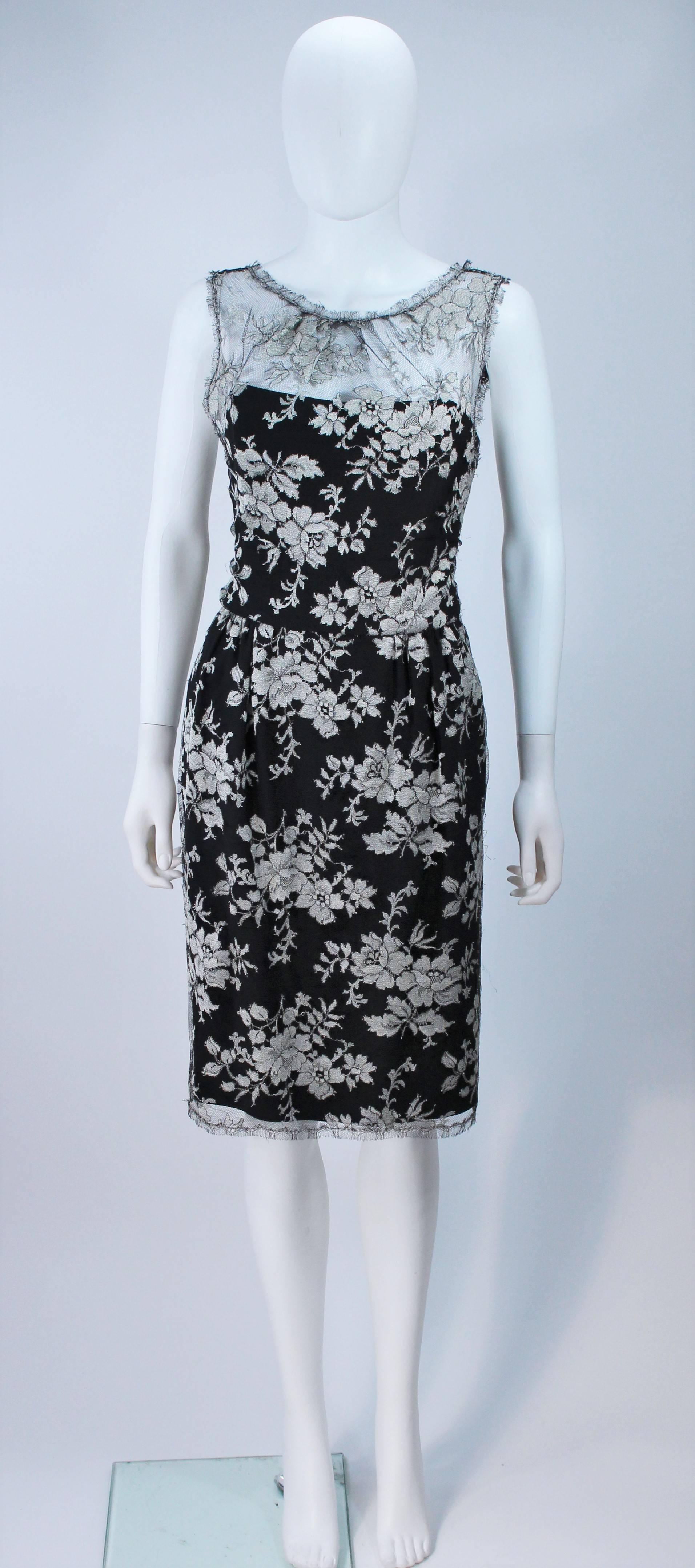  This Monique Lhuillier  cocktail dress is composed of a black and silver lace, with silk lining. Features scalloped edges with a center back zipper closure and key hole opening. There is interior boning and side pockets. In great condition. 
   
 