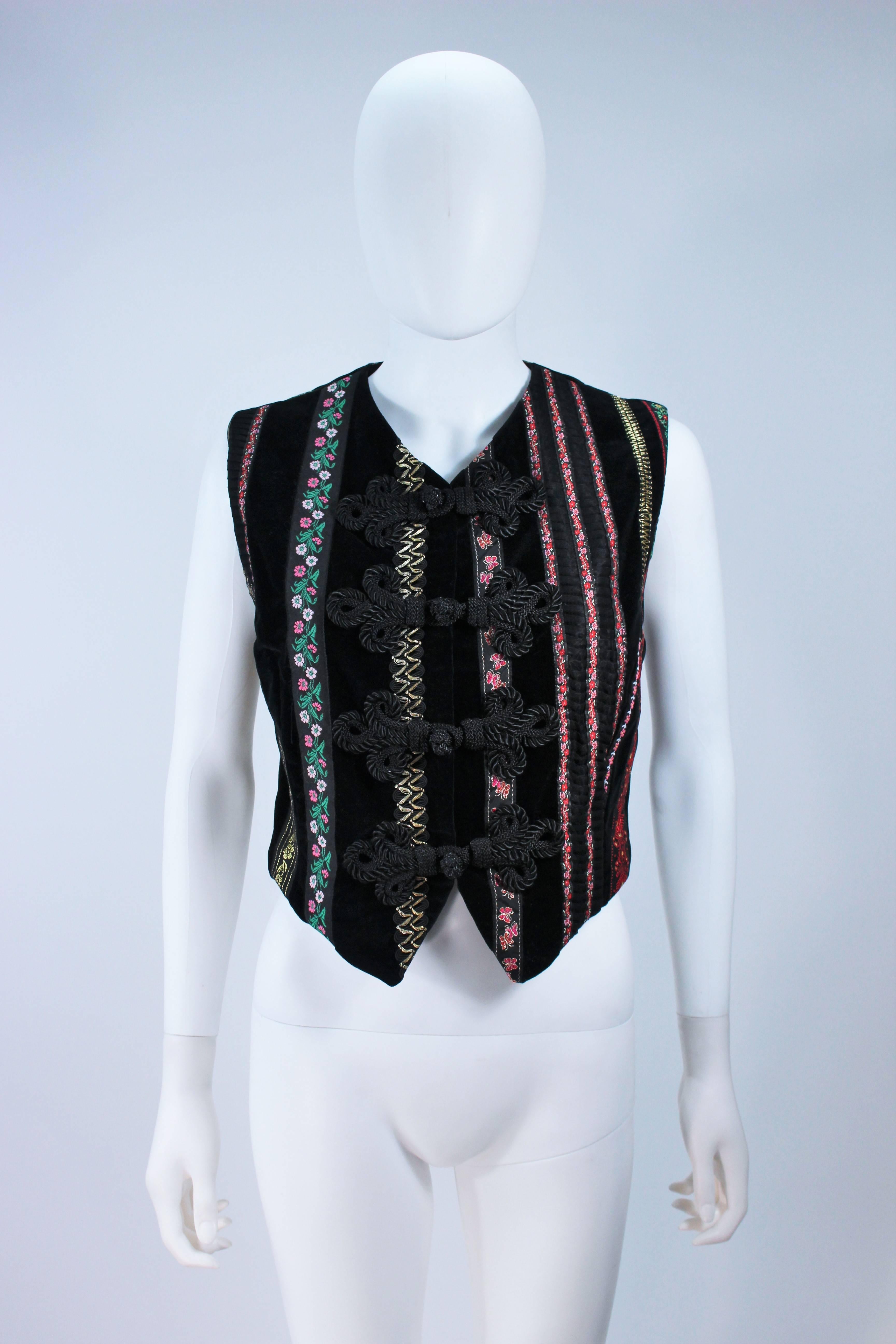  This Dolce and Gabbana  vest is composed of a black velvet with multi-color trim. Features knot style button closures. In great vintage condition. 

  **Please cross-reference measurements for personal accuracy. Size in description box is an