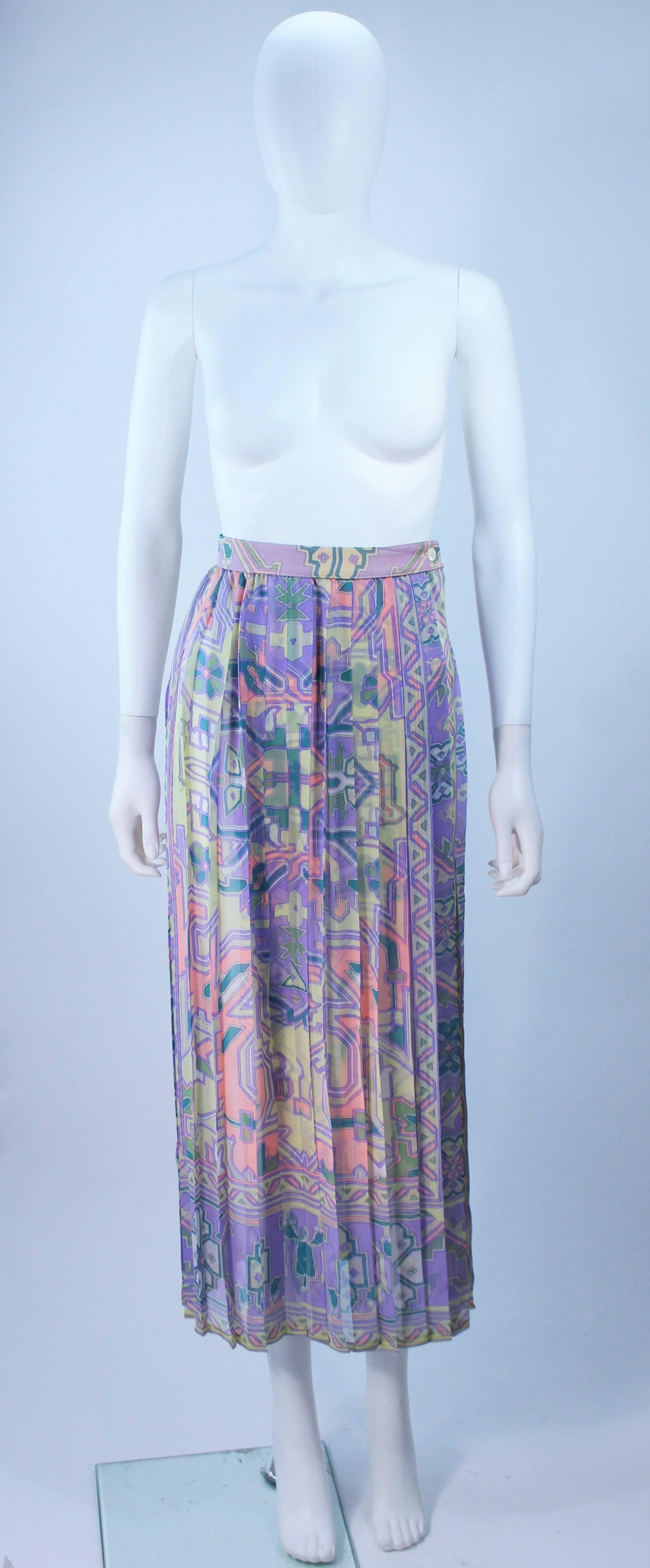  This Ungaro  skirt is composed of a sheer patterned fabric, with pleating. There is a side slit and single button closure. In great vintage condition. 

  **Please cross-reference measurements for personal accuracy. Size in description box is an