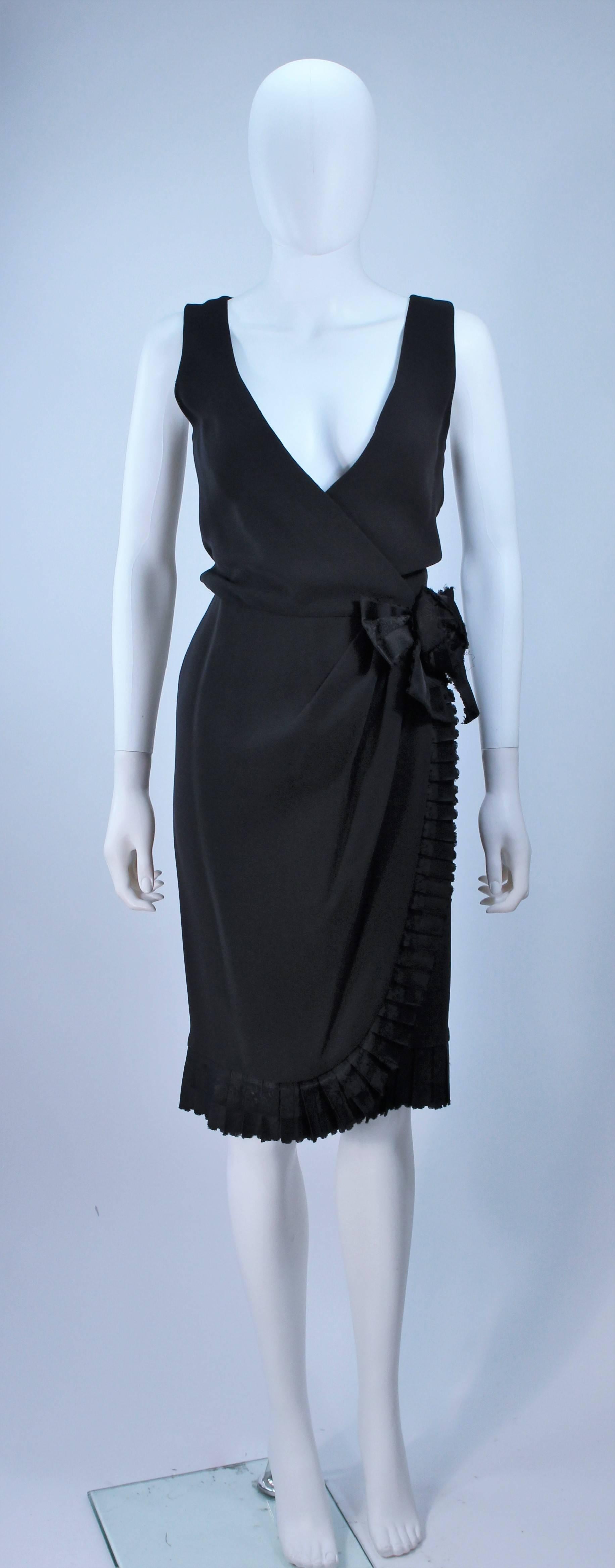  This Bill Blass  dress is composed of a black silk. Features a wrap style with side drape and rose accent. There are hook and closures with snaps. In great vintage condition. 

  **Please cross-reference measurements for personal accuracy. Size