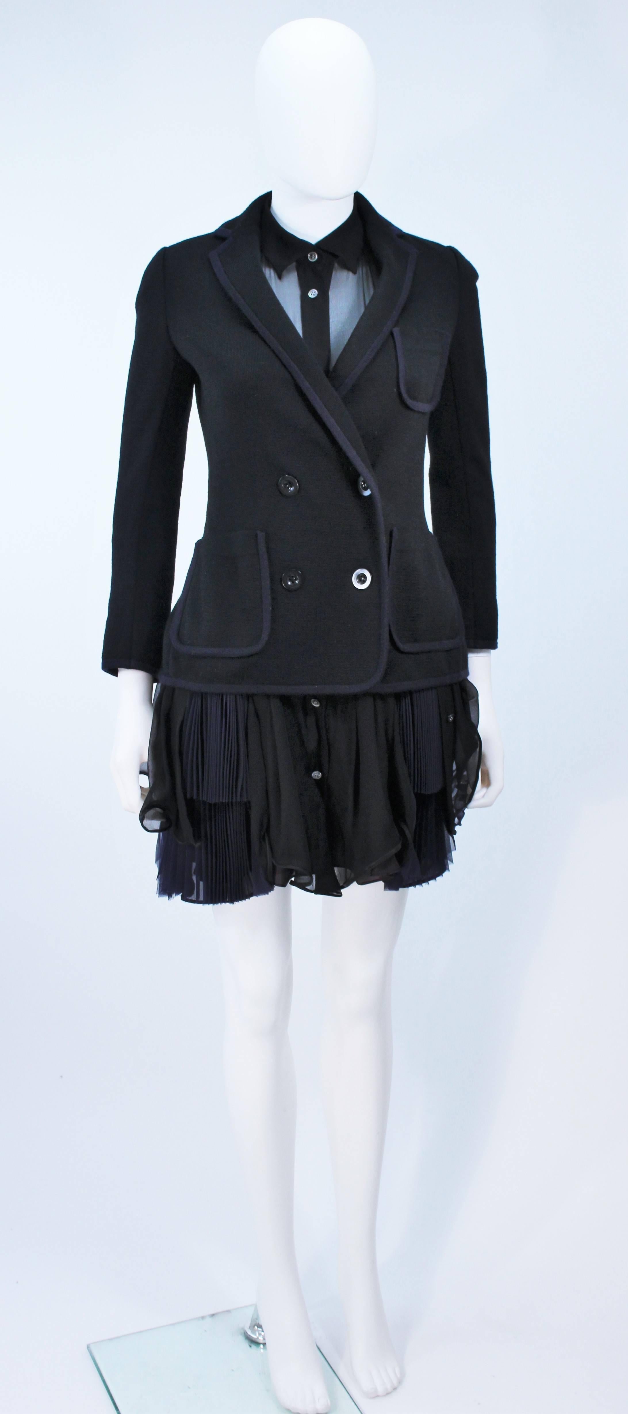  This Comme Des Garcon ensemble features a stretch double breasted wool jacket and chiffon dress. The dress has center front button closures and a hip gathering detail. The two pieces are attachable thru buttons. In new condition, with original