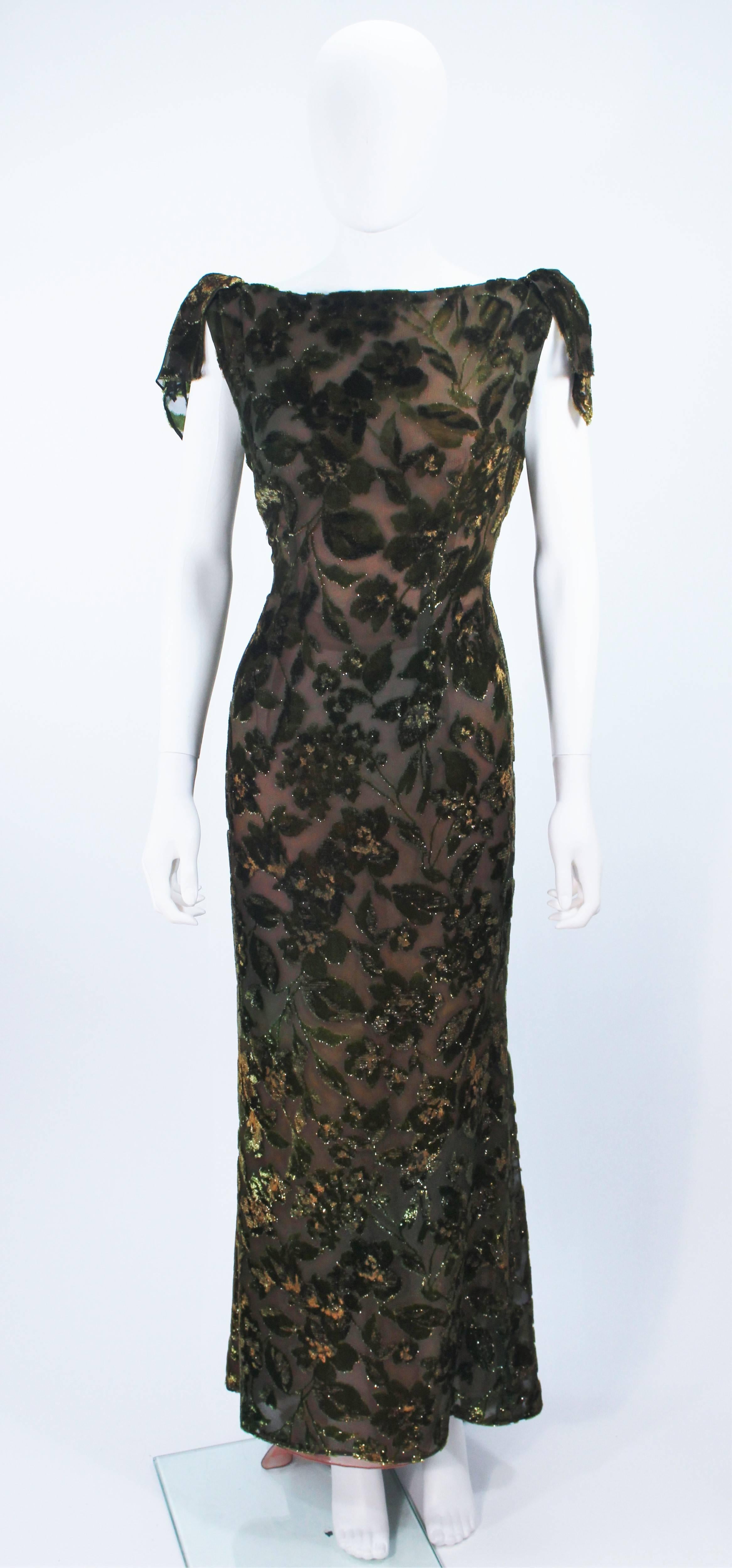  This gown is composed of a green multi hue metallic silk velvet. Features a draped design with shoulder bow detail and center back zipper. This design is semi-sheer with a nude lining. In great vintage condition. 

  **Please cross-reference