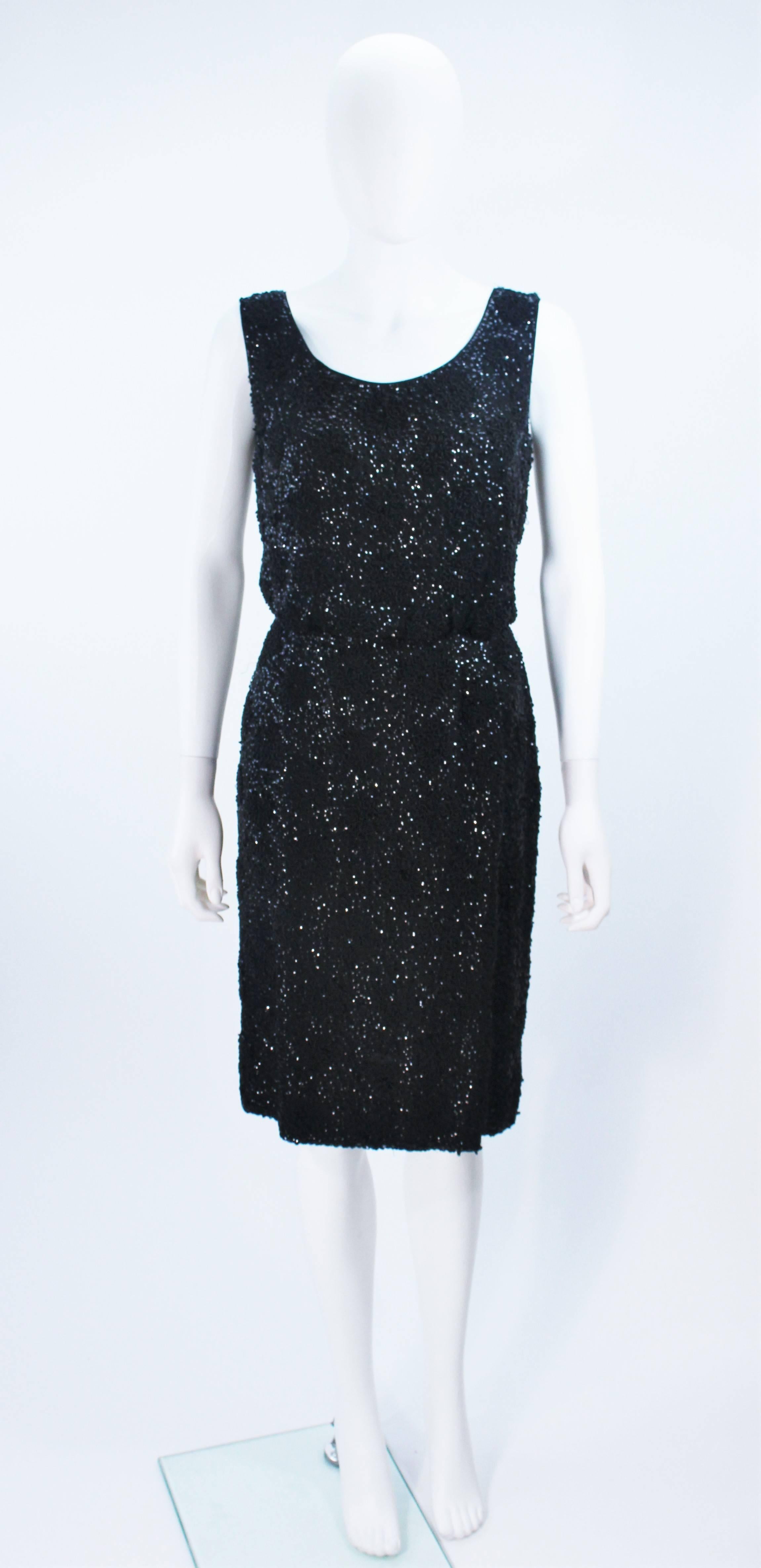  This cocktail dress is composed of a black silk chiffon with floral patterned beading throughout. There is a center back zipper closure. In great vintage condition. 

  **Please cross-reference measurements for personal accuracy. Size in
