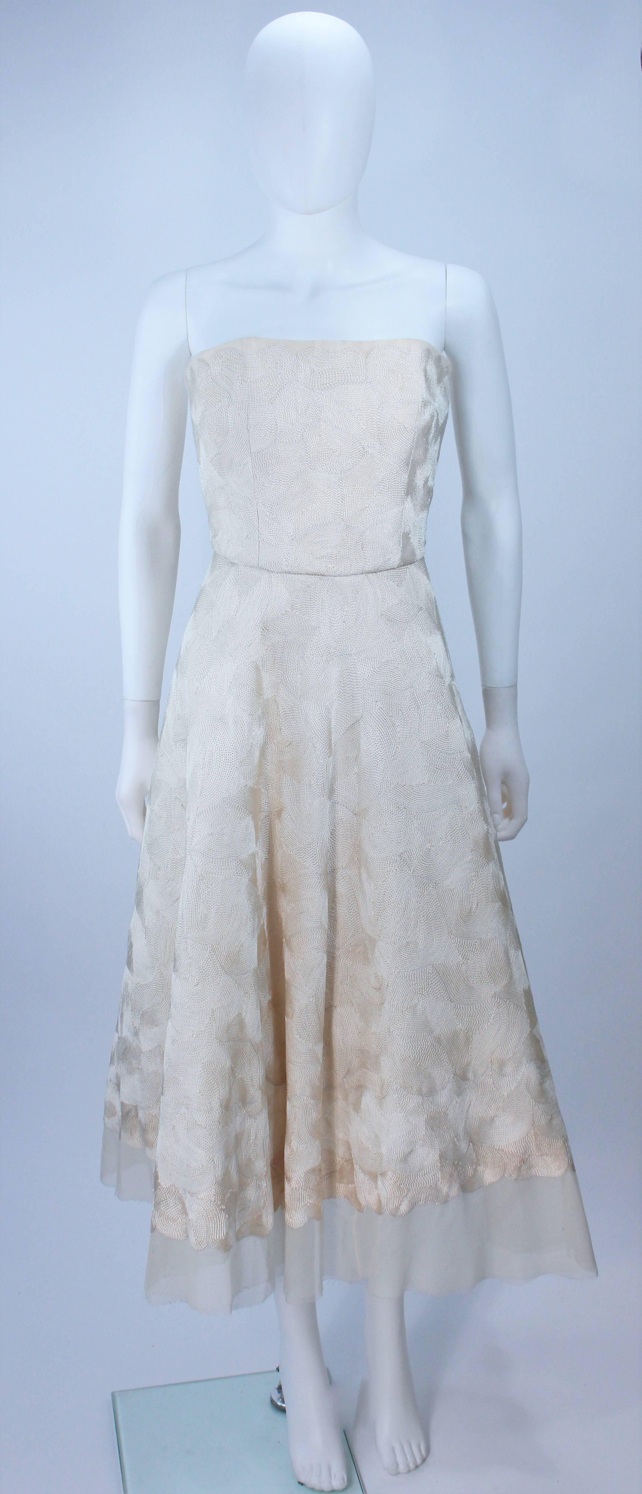 This Elizabeth Mason Couture features a cocktail strapless dress with crinoline interior structure, bolero, and belt. Made in Beverly Hills. 

 The gown may be fashioned in a variety of colors. 

This is a couture custom order. Please allow for a 60