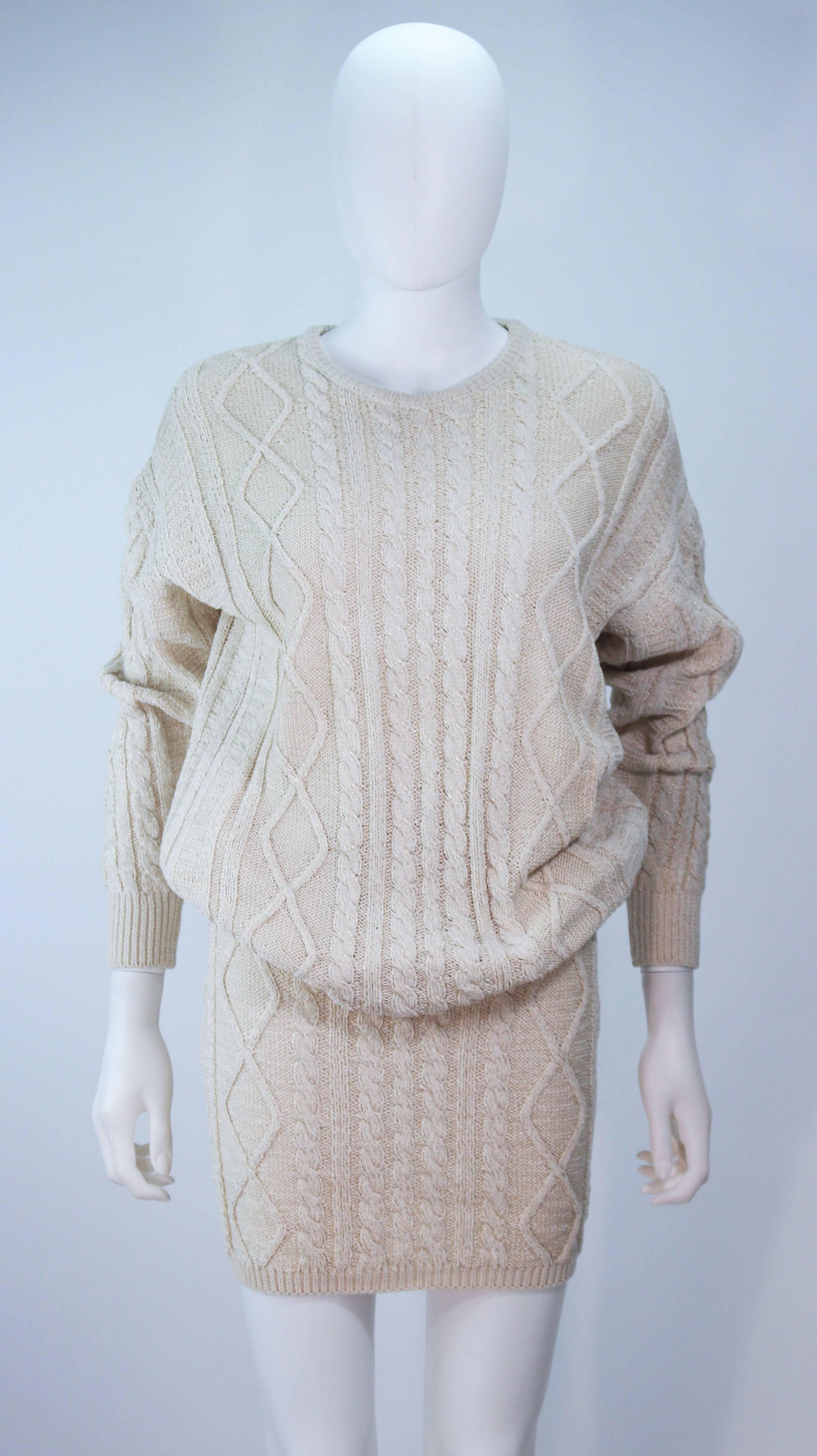 This Gianni Versace set is composed of a nude cable knit. Pull on style over sized sweater and pencil skirt. In excellent condition. 

  **Please cross-reference measurements for personal accuracy.  

Measures