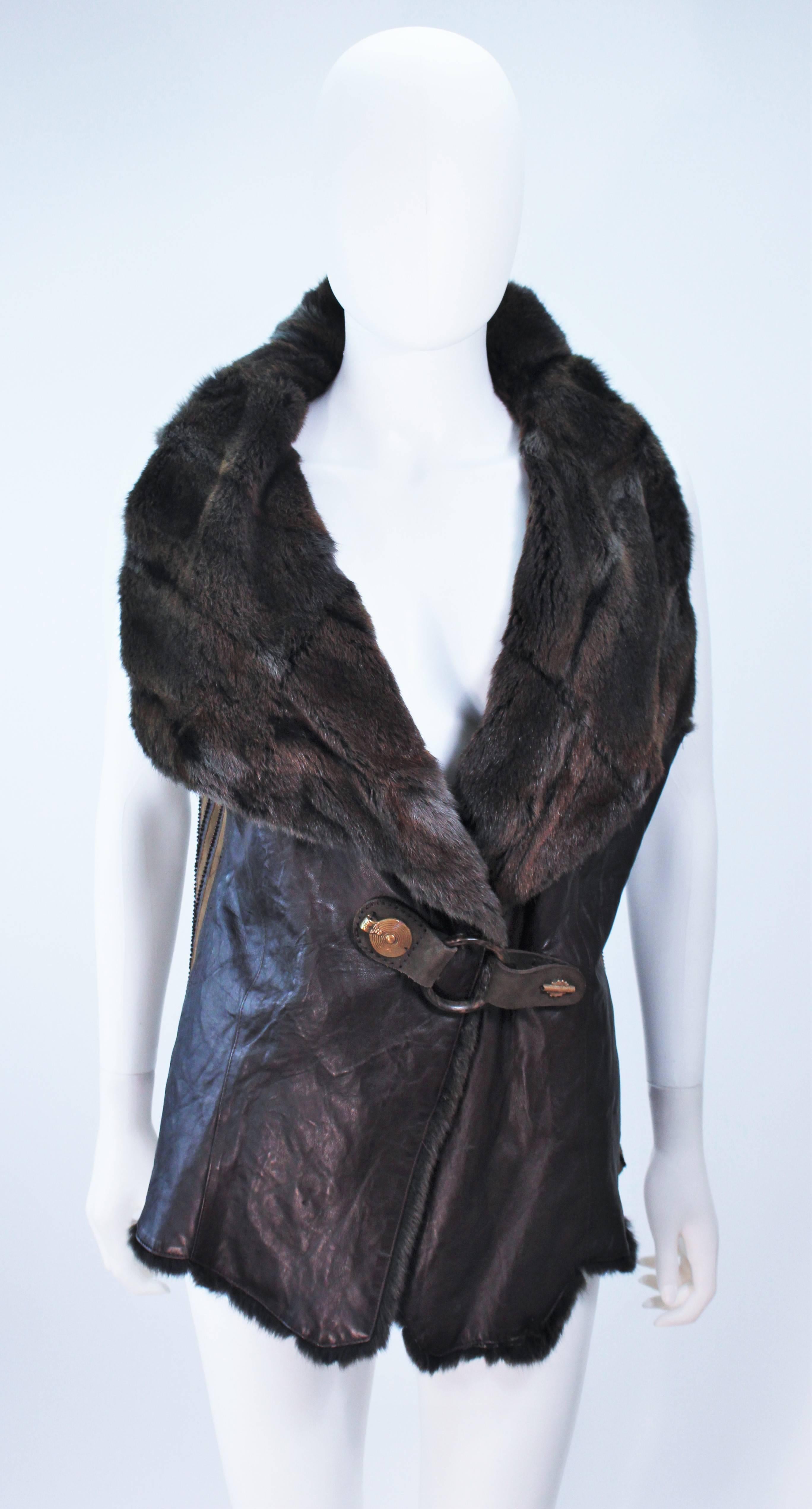 This Anna Trzebinski vest is composed of a brown leather with a brown drab hue fur interior. Features a horn belt closure with snaps. In excellent condition. 

  **Please cross-reference measurements for personal accuracy.  

Measures