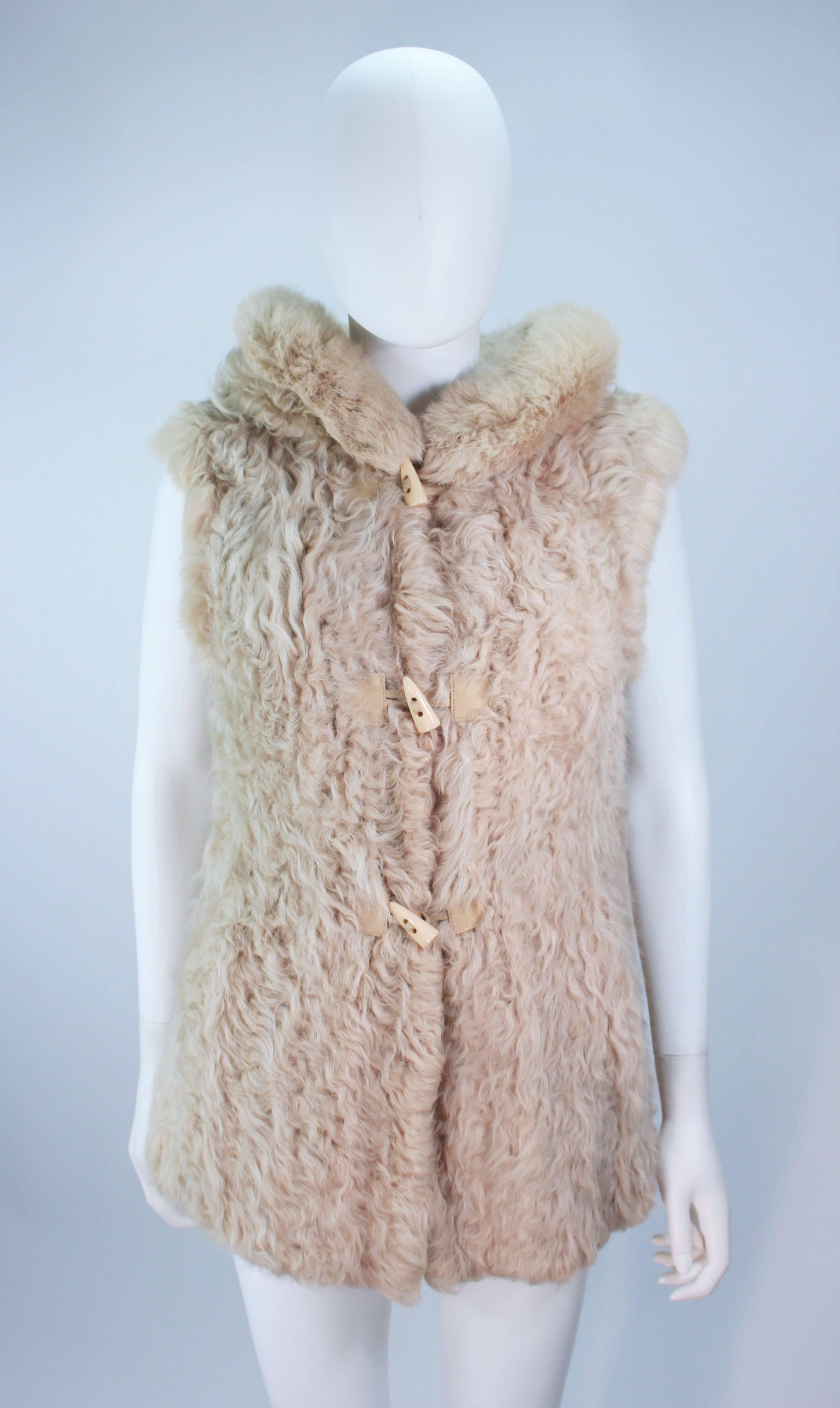  This Neiman Marcus Vest is composed of a lamb and rabbit fur combination. Features toggle closures and a generous sized hood. In excellent condition. 

  **Please cross-reference measurements for personal accuracy.  

Measures