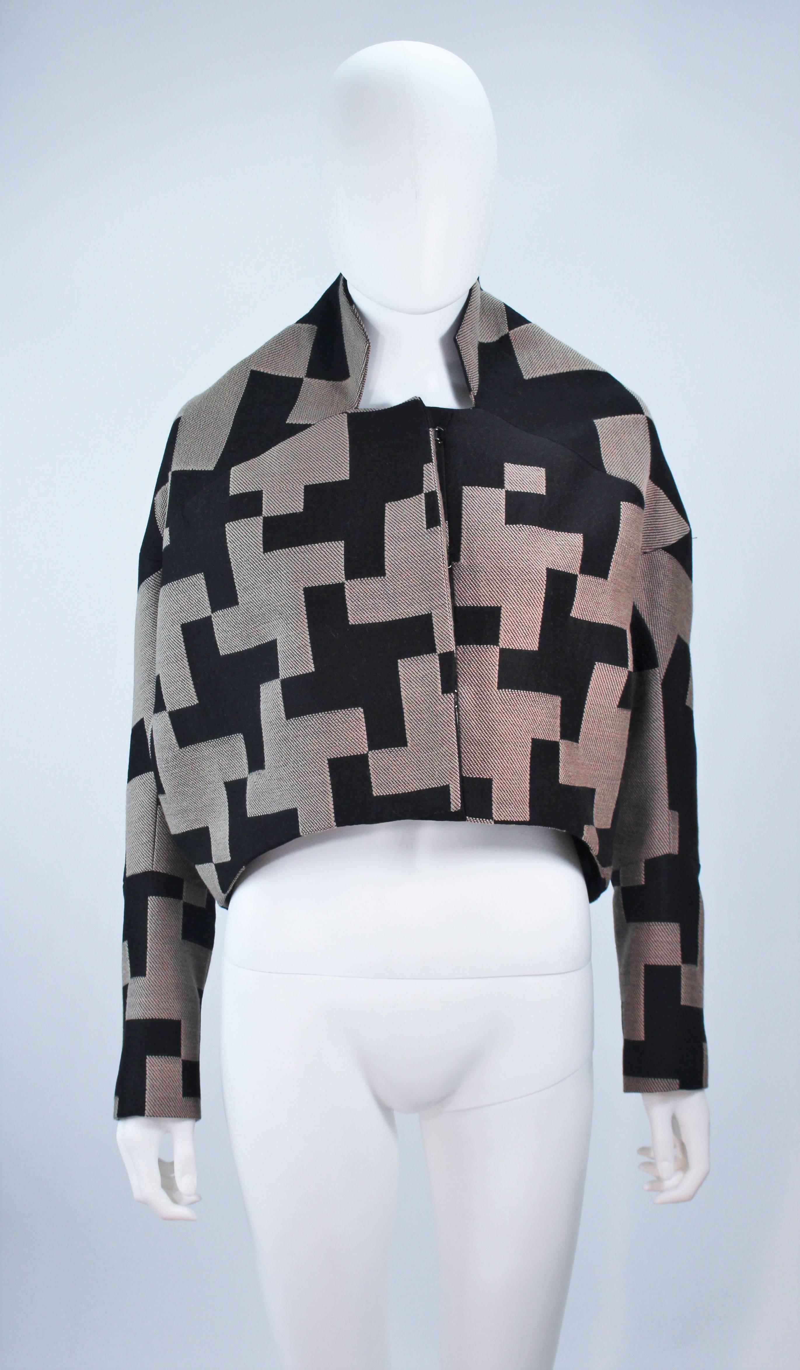 This Maria Cornejo jacket is made of a navy and beige geometric print. There are center front hook and eye closures. In excellent condition, unused with original tags. 

  **Please cross-reference measurements for personal accuracy.  

Measures