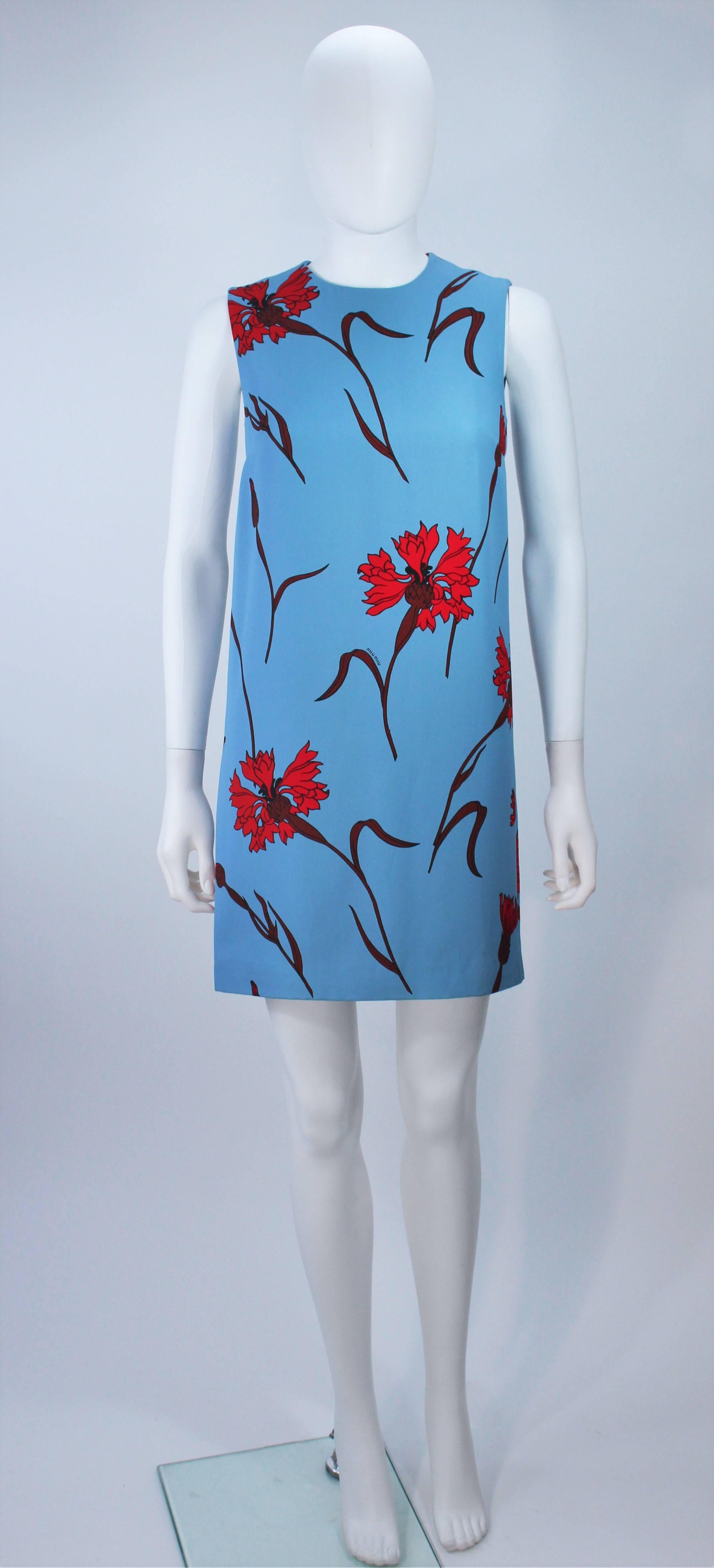 This Miu Miu dress is composed of a blue floral print. Features a center back zipper closure with hook and eye. In excellent unused condition, with original tags. 

  **Please cross-reference measurements for personal accuracy.  

Measures