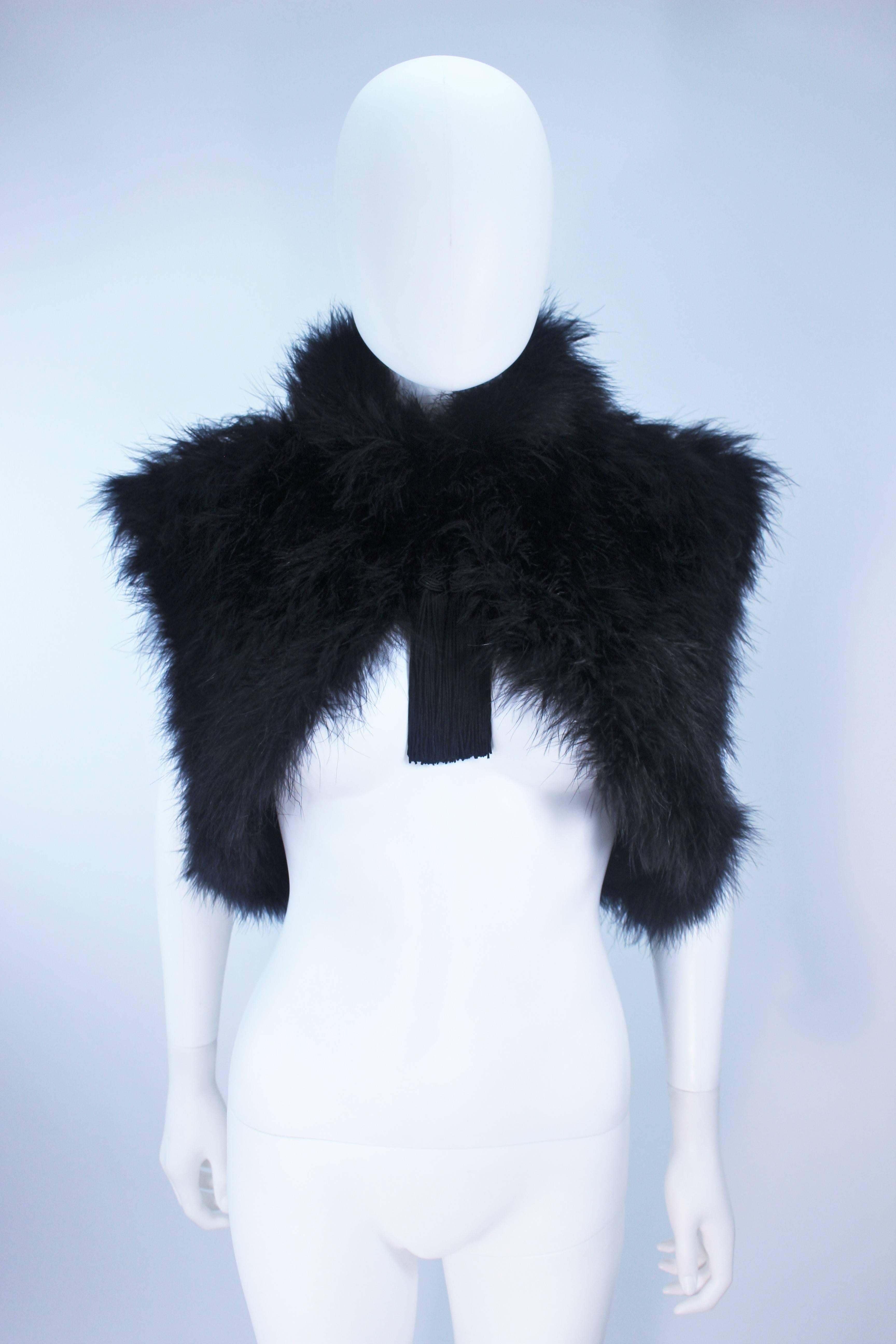 This Elizabeth Mason Couture Marabou  garment is composed of a supple marabou in a stunning black hue. Features a hook and eye closure with center front tassels. Designed in Beverly Hills.

This is a couture custom order. Please allow for a 60 day