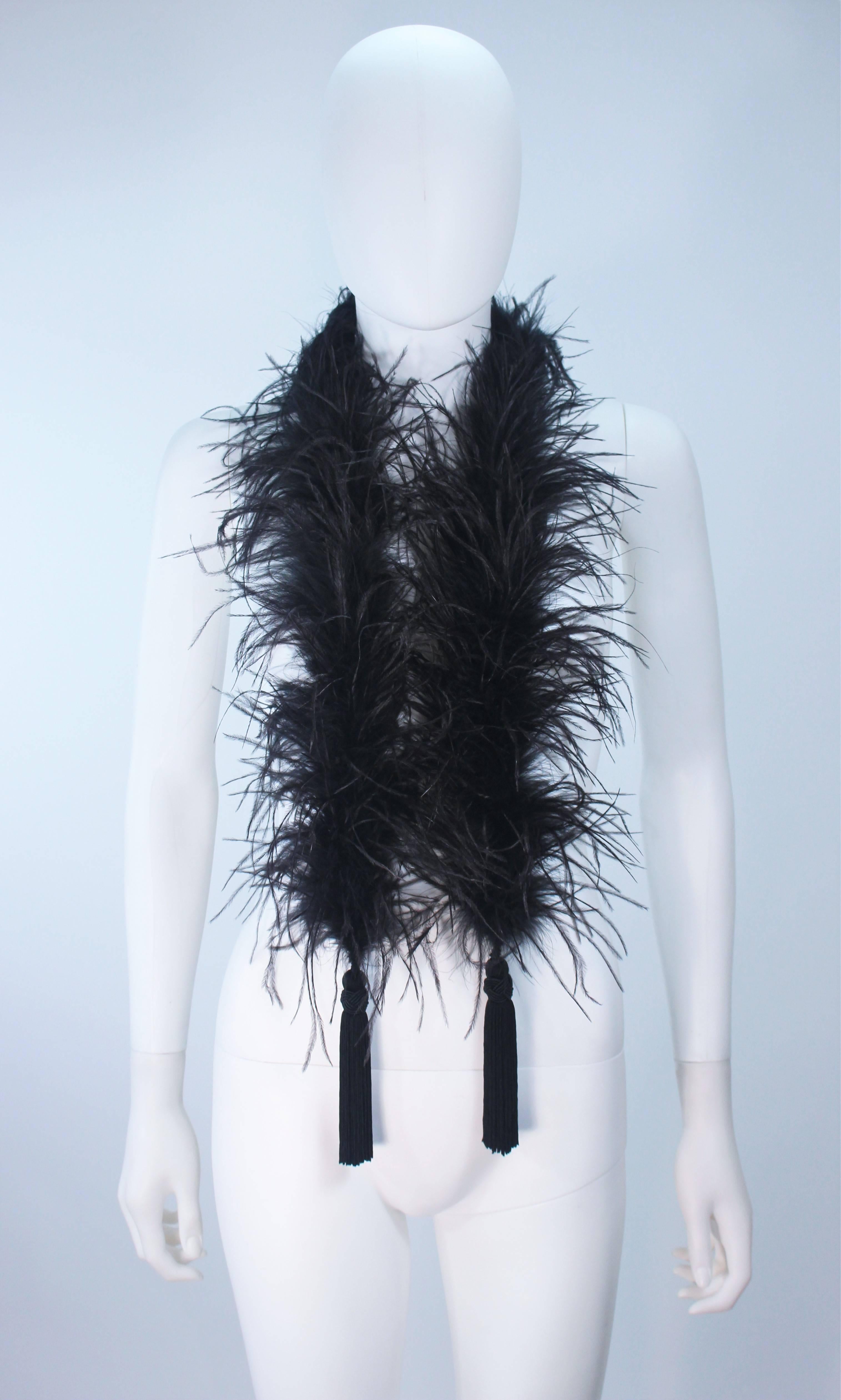 This Elizabeth Mason Couture ostrich boa is composed of a black ostrich. Features two tassels. Designed in Beverly Hills.

Measures (Approximately) 
Length: 54