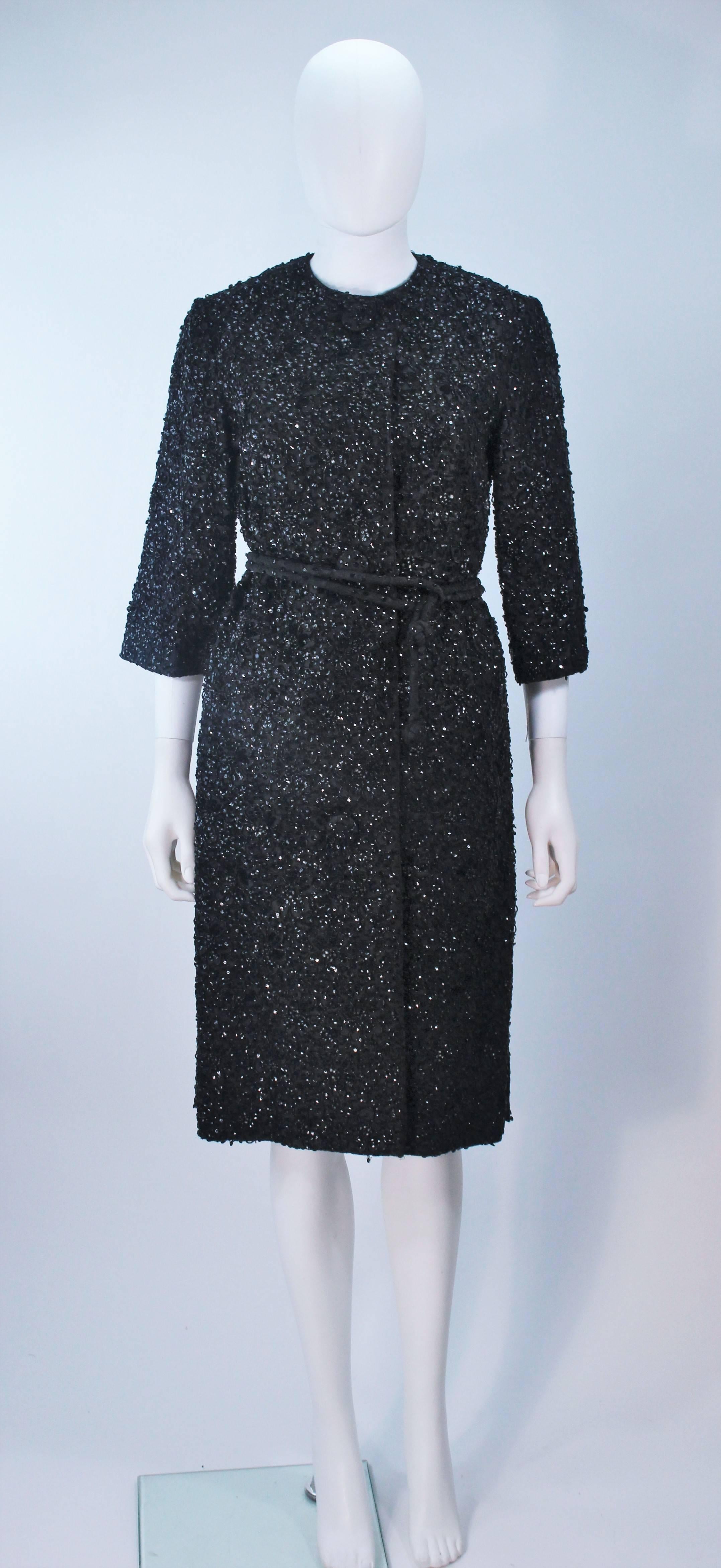 This Haute Couture International coat is composed of a black beaded and sequin lace. There are center front button closures with a matching beaded belt. There are side pockets. In excellent vintage condition, with original tags. 

  **Please