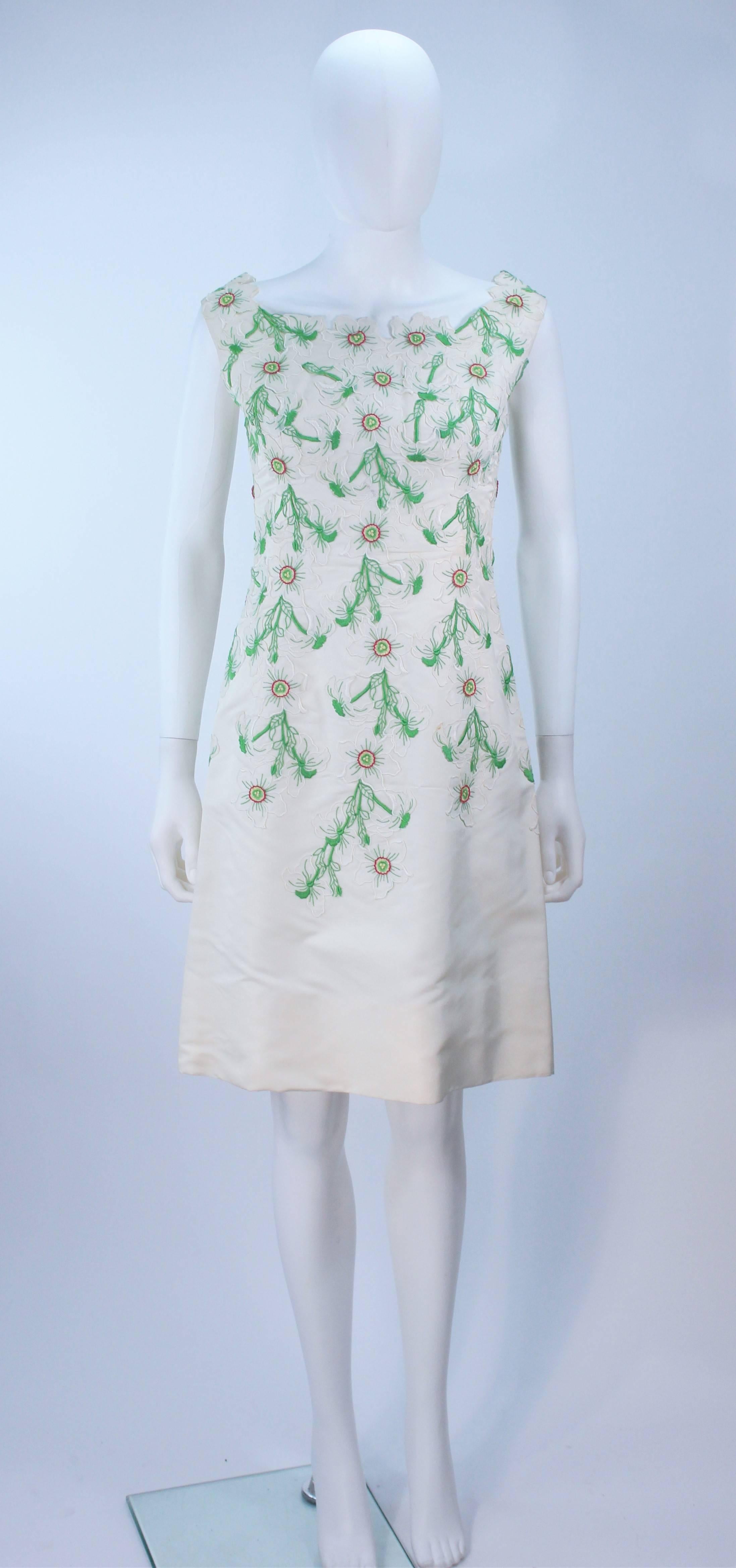  This dress is composed of an off-white silk with floral pattern. There is a center back zipper closure with v-back. In excellent vintage condition.

  **Please cross-reference measurements for personal accuracy. Size in description box is an