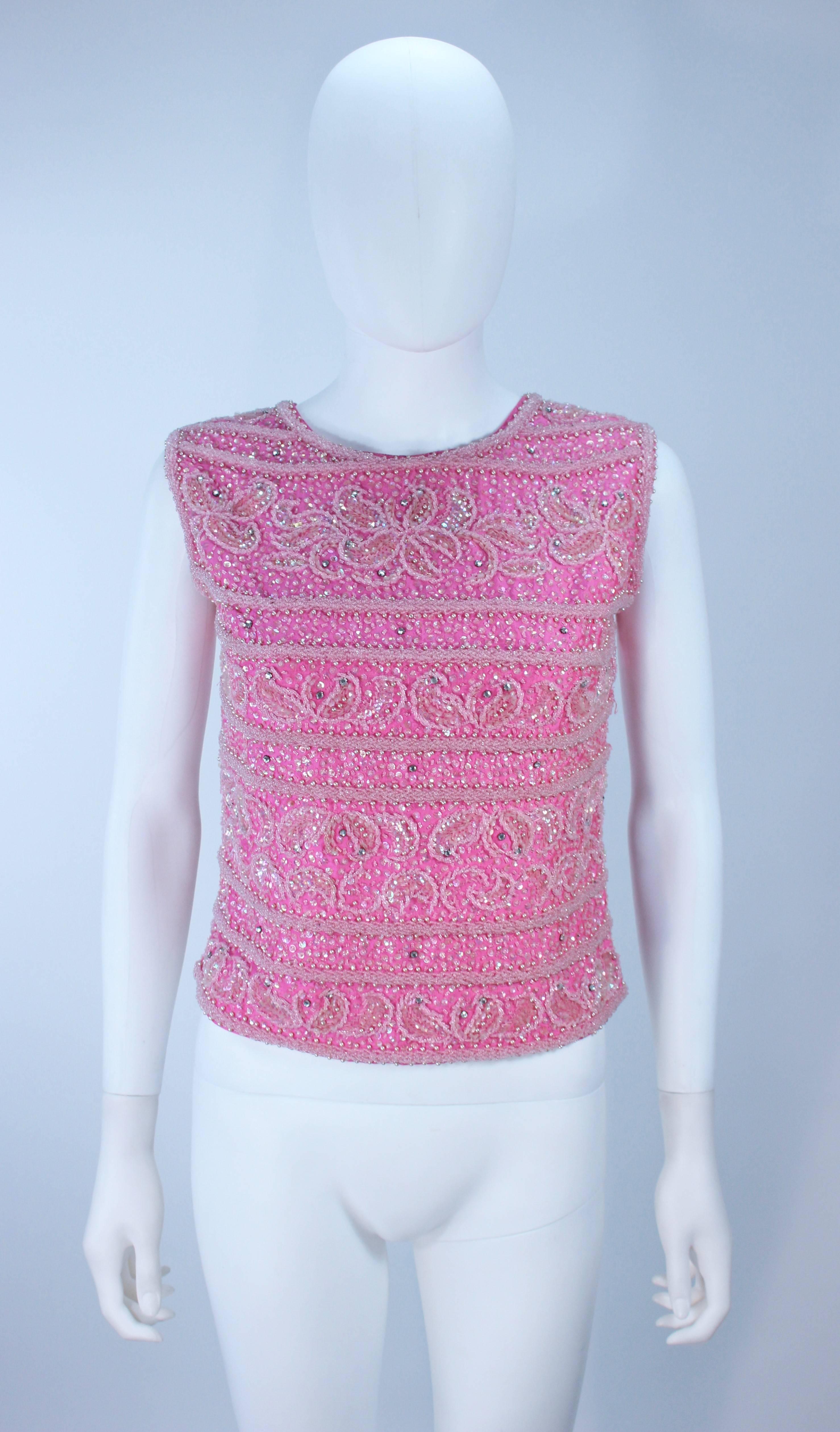  This blouse is composed of a pink heavily embellished fabric with a floral pattern. There is a center back zipper closure. In excellent vintage condition.

  **Please cross-reference measurements for personal accuracy. Size in description box is