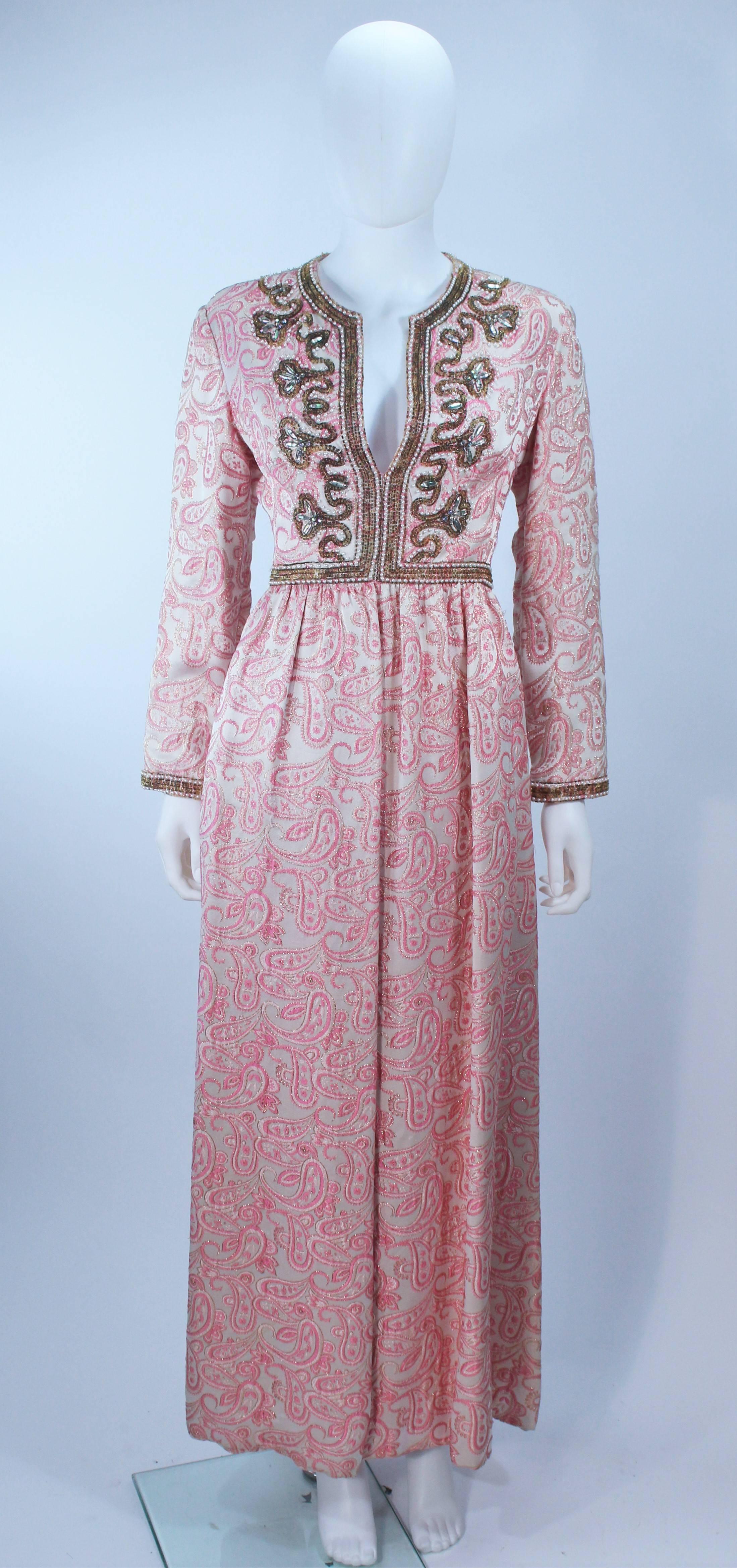 This Ceil Chapman gown is composed of a pink paisley brocade and features an embellished neckline. There are side pockets with a center back zipper closure. In excellent vintage condition.

  **Please cross-reference measurements for personal