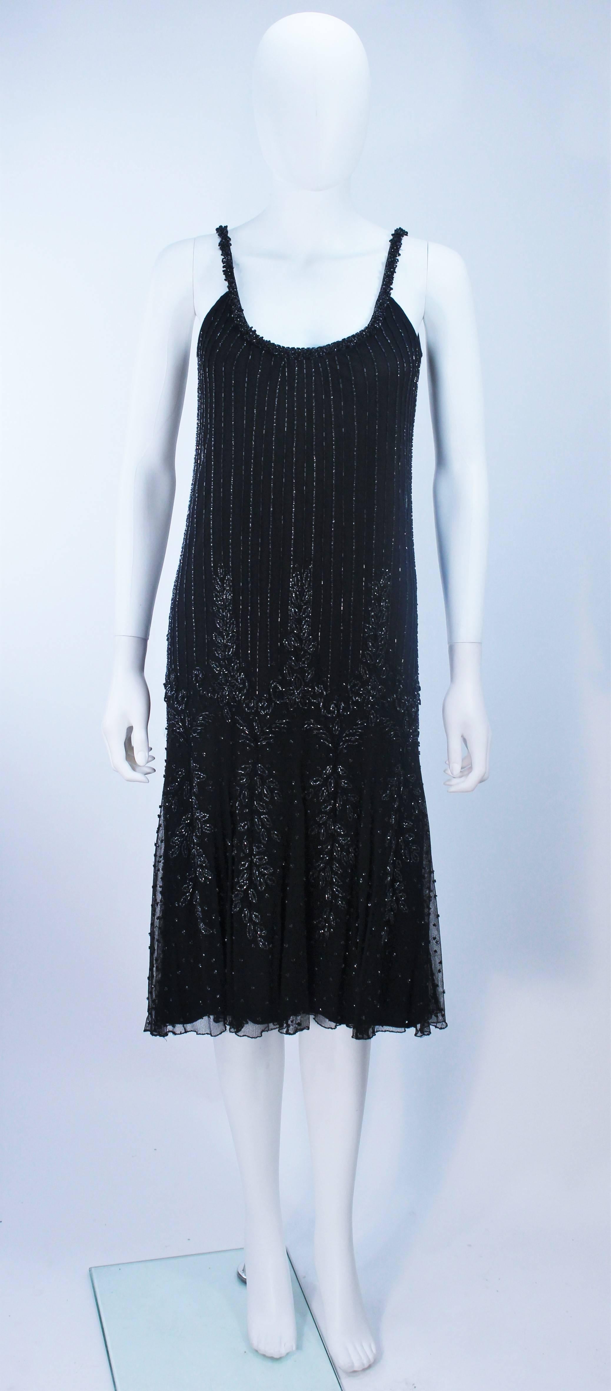 This Carlota Alfaro dress is composed of a beaded black mesh with a jersey underlay. There is a zipper closure. In excellent vintage condition.

  **Please cross-reference measurements for personal accuracy. Size in description box is an
