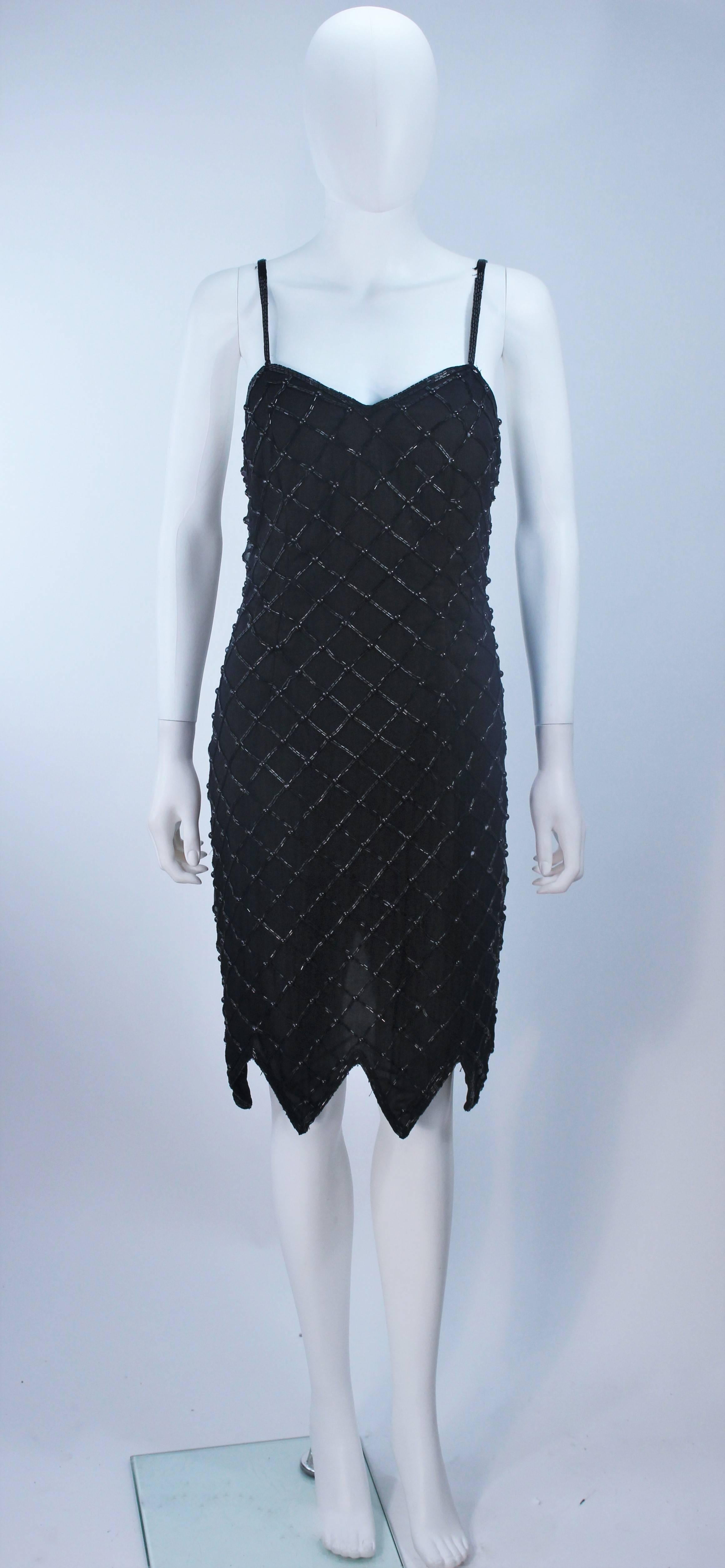  This cocktail dress is composed of a beaded black rayon with a scalloped hem. There is a zipper closure. In good vintage condition, some wear to beading.

  **Please cross-reference measurements for personal accuracy. 

Measures