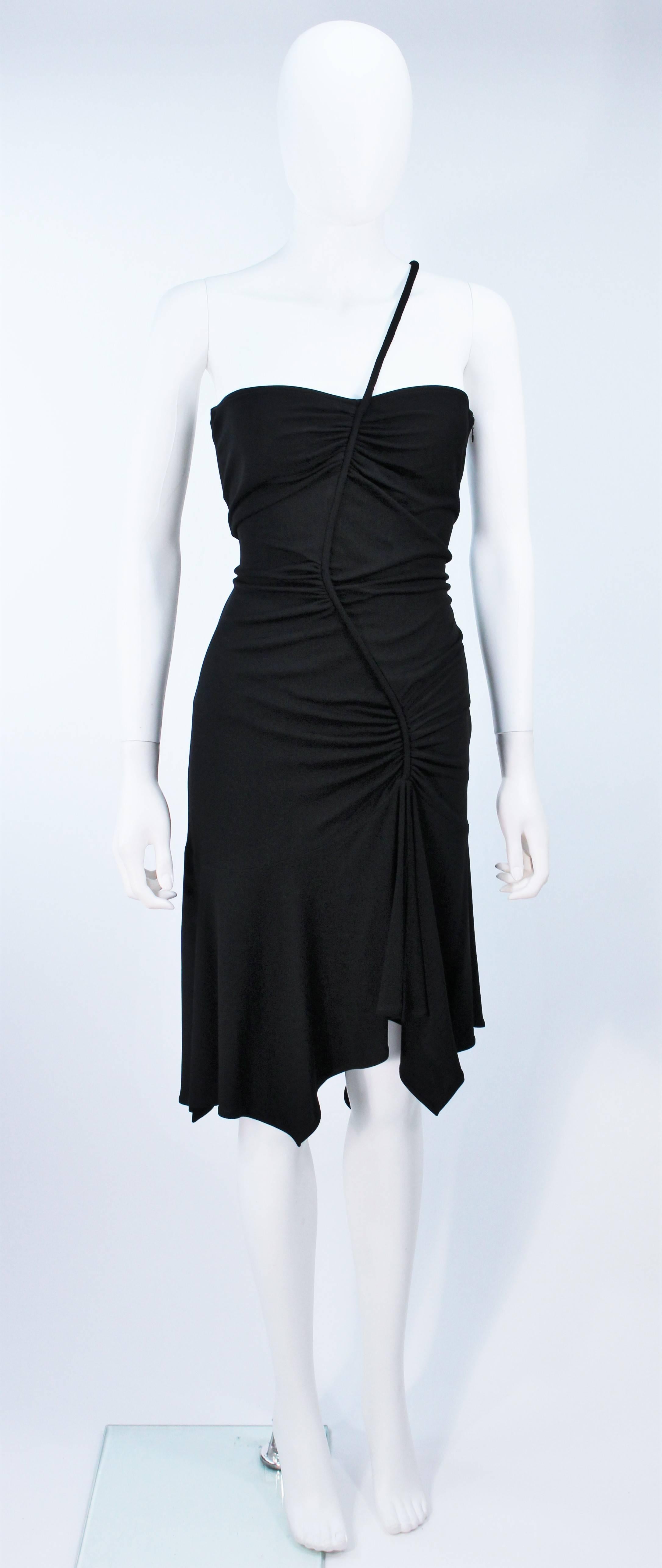 This Versace design is available for viewing at our Beverly Hills Boutique. We offer a large selection of evening gowns and luxury garments. 

 This cocktail dress is composed of a black stretch jersey. Features a side zipper closure with an