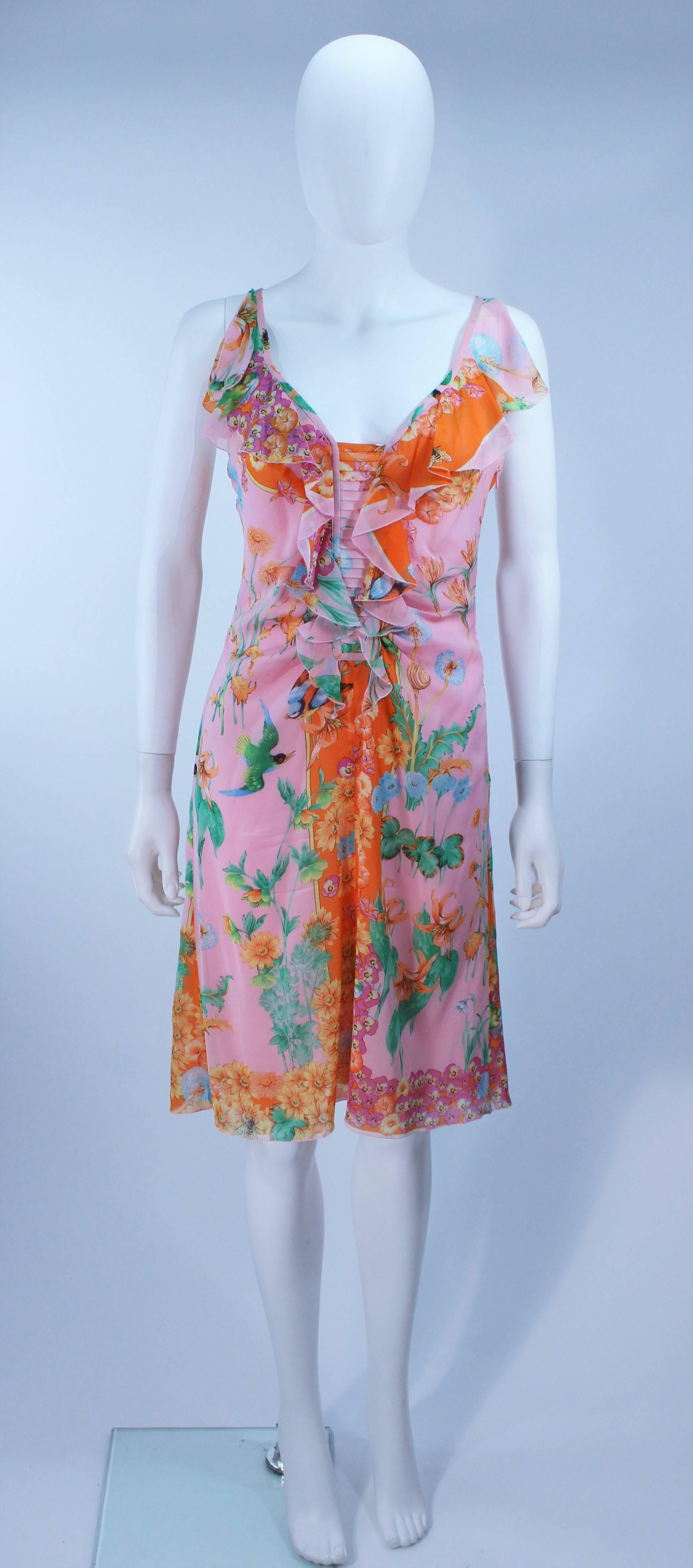 This Versace  cocktail dress is composed of a stretch light weight silk with floral pattern. Features a pleated front with ruffle details. There is a zipper closure. In excellent vintage condition.

  **Please cross-reference measurements for