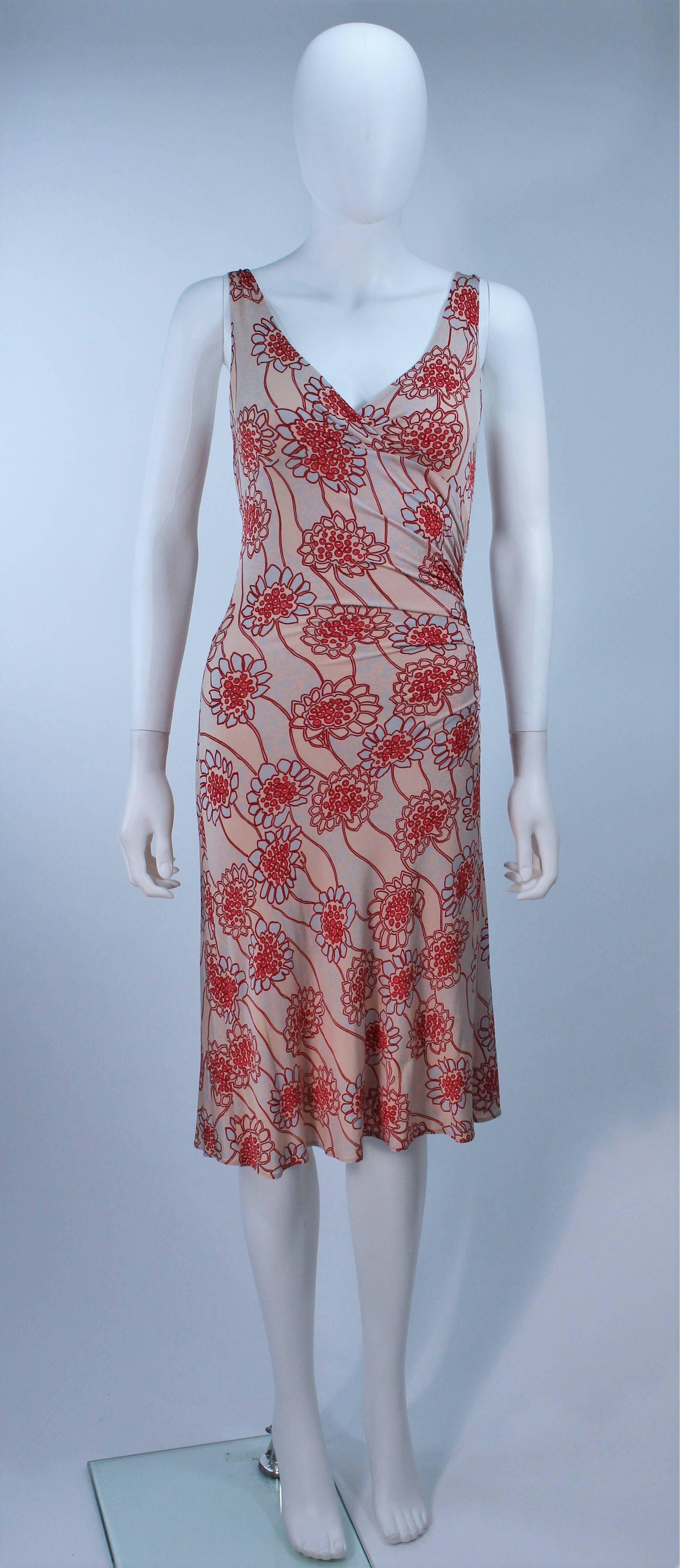 This Lida Baday  dress is composed of a stretch lightweight floral print fabric in shades of pale pink and beige. Features a side ruching. In excellent pre-owned condition.

  **Please cross-reference measurements for personal accuracy.