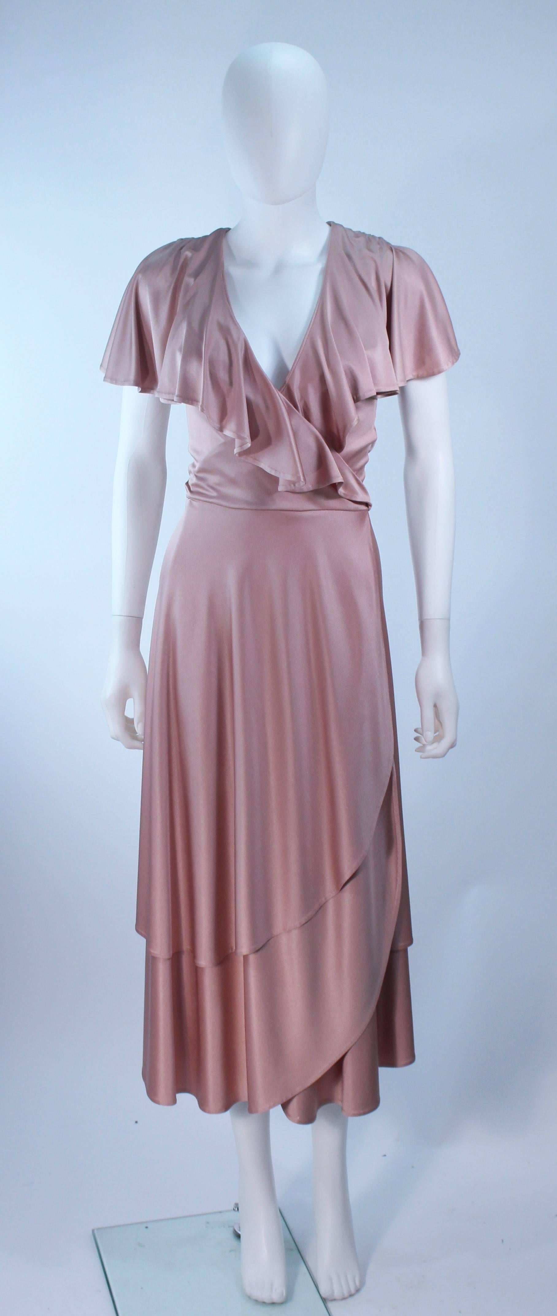This Elizabeth Mason Couture 
This gown is composed of a pink mauve silk jersey ('Blush' hue) and features a draped ruffle design. This cocktail dress has a waist wrap. This effortlessly chic gown can be styled in a variety of fashions. Made in