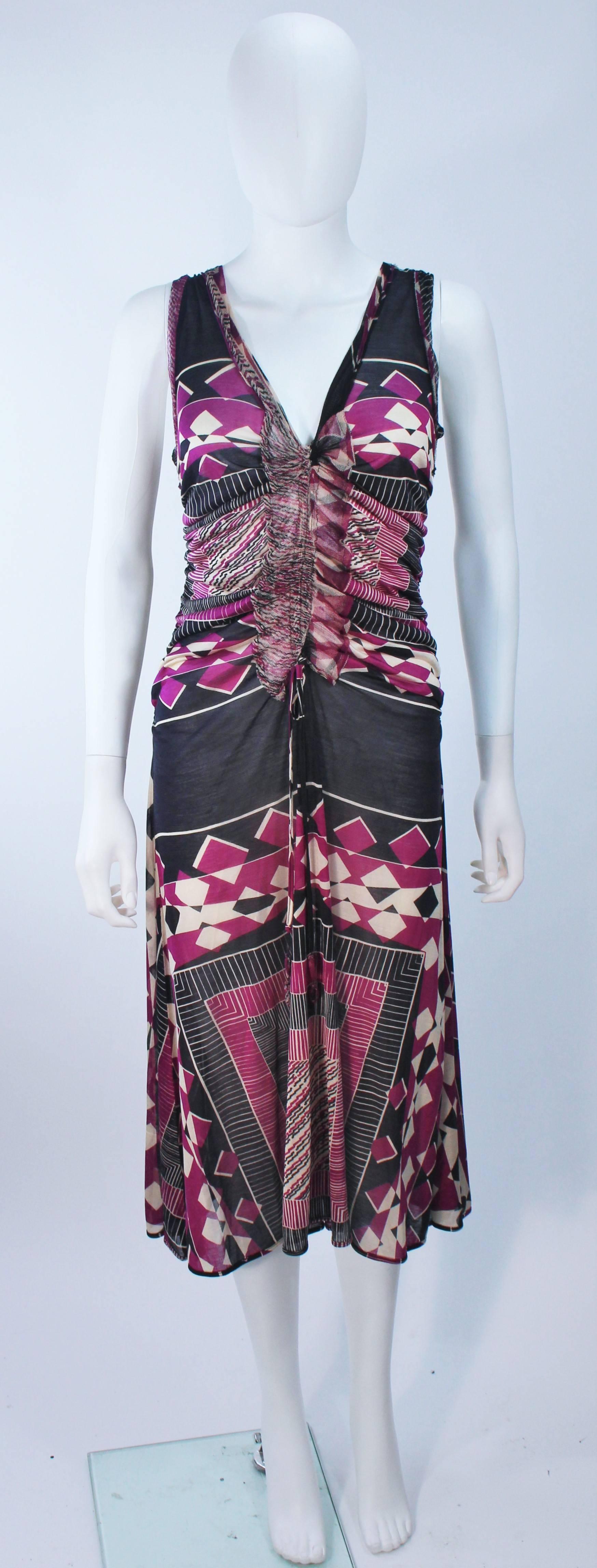 This Jean Paul Gaultier  cocktail dress is composed of a sheer stretch knit in pink, black, and white hues. Features a ruched front and a pull over style. In excellent unused condition, with original tags. Made in Italy.

  **Please