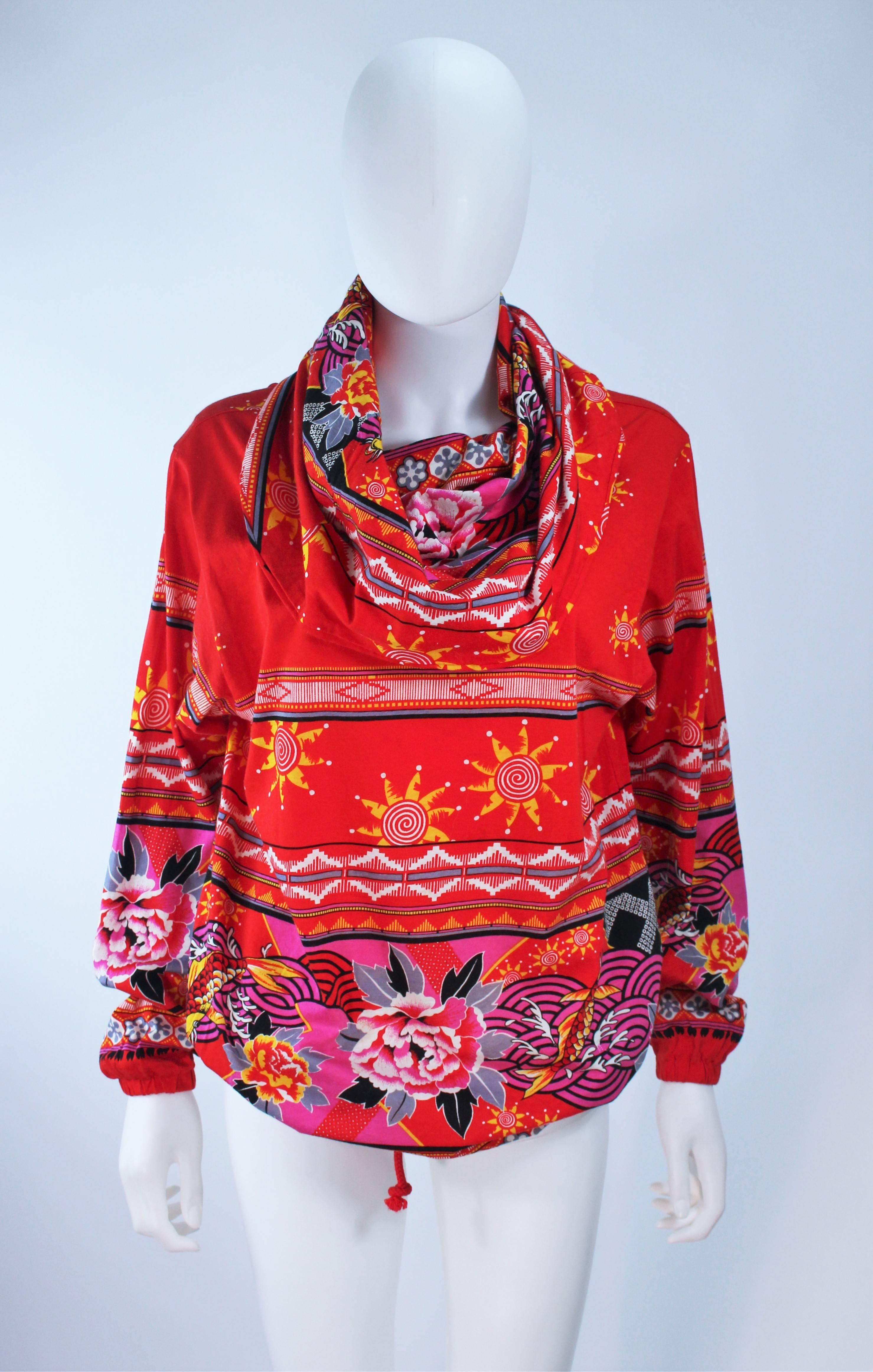 This Kansai Japan  top is composed of red printed knit with a floral and solar design. Features a pull on style with a large collar which can be styled as a hood. There is a waist tie. Made in Japan. In excellent unused condition.

  **Please