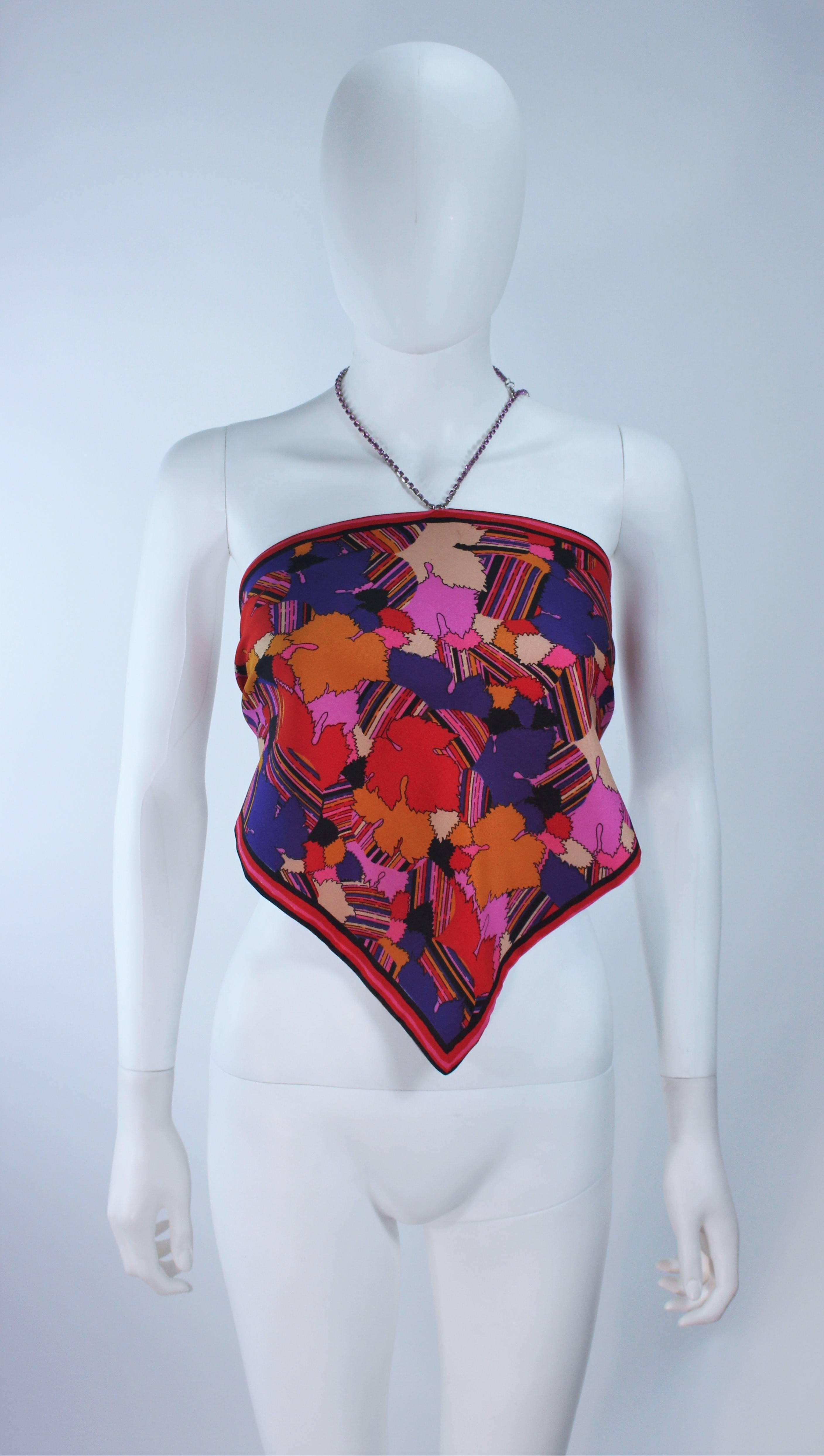 This Mary Quant  top is composed of an abstract printed silk and features a rhinestone neck tie with a halter style. There are some rhinestones missing from the halter chain. 

  **Please cross-reference measurements for personal accuracy.