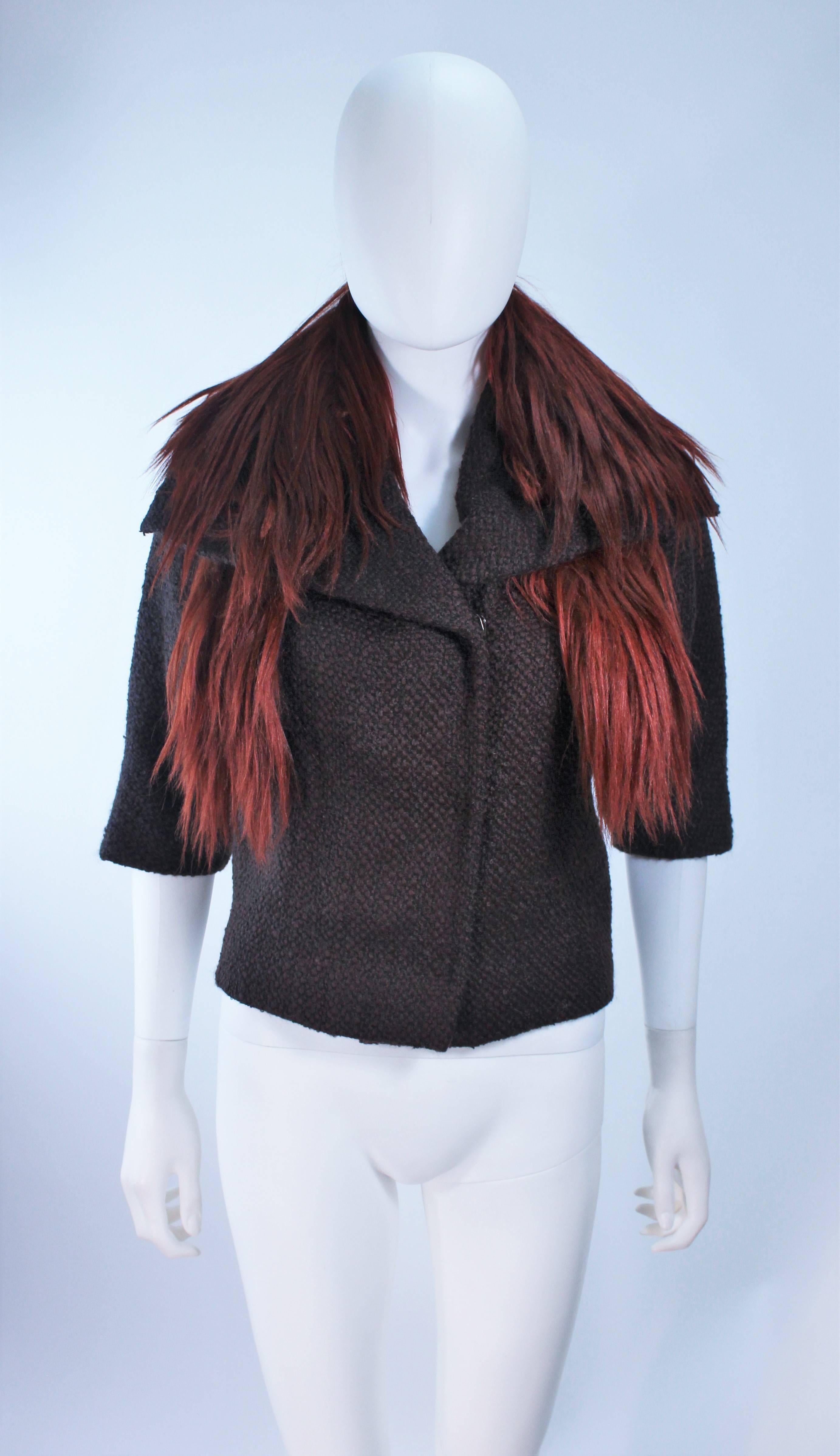 This Etro jacket is composed of a brown wool and features a orange goat fur collar. There are center front snap button closure. Removable collar. In excellent condition.

  **Please cross-reference measurements for personal accuracy. Size in