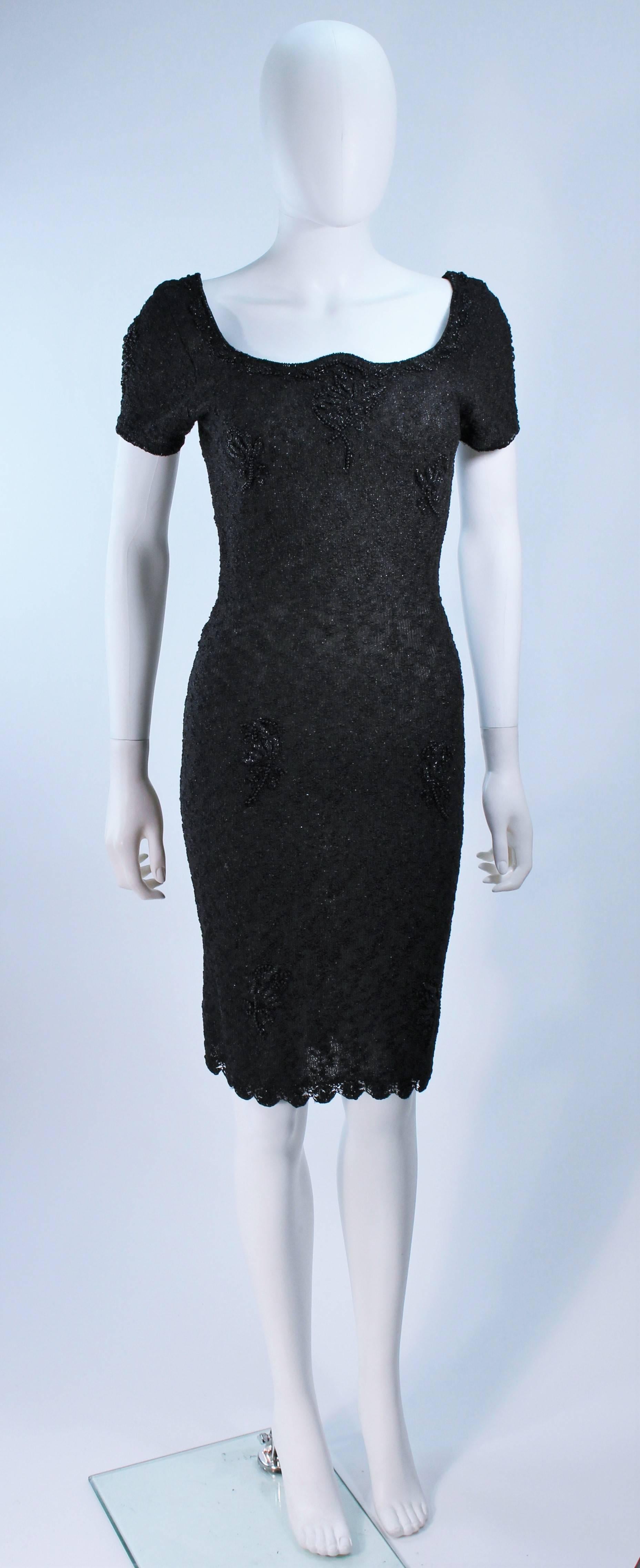  This dress is composed of a black knit wool with beaded applique. Features a pullover style accentuated bust and back with scalloped edge. Semi-sheer. In excellent vintage condition. 

  **Please cross-reference measurements for personal