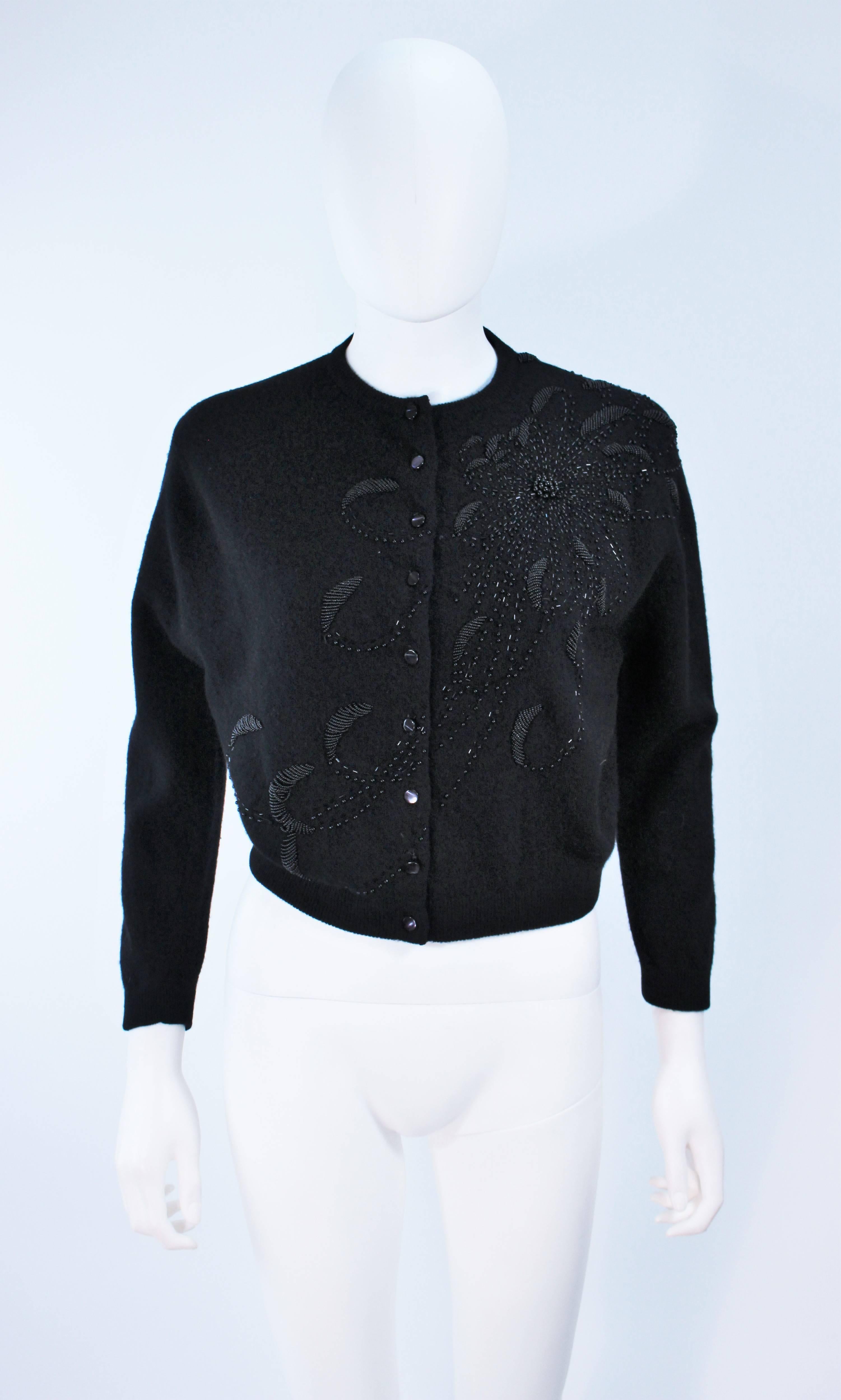 This Schiaparelli  sweater is composed of a black wool with floral starburst beaded design. Features center front button closures and silk lining. In excellent vintage condition.

  **Please cross-reference measurements for personal accuracy.