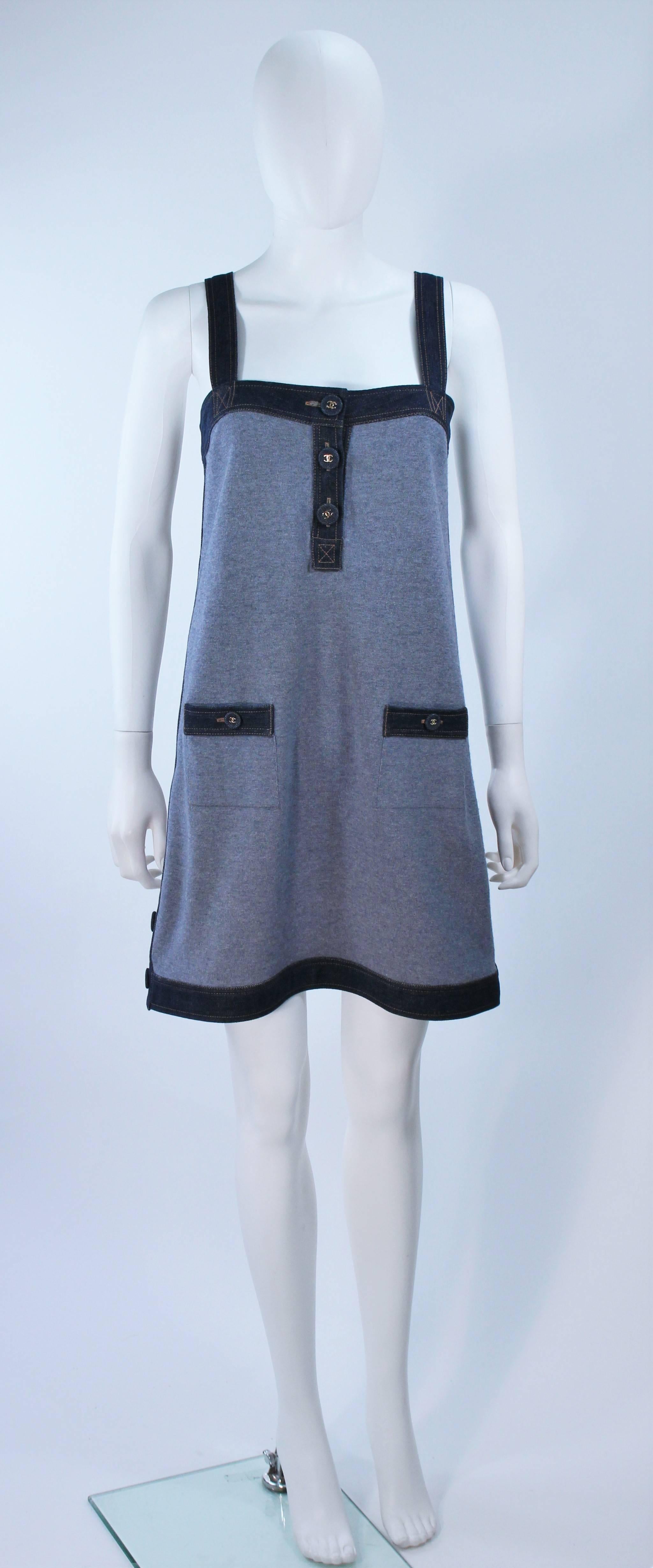 This Chanel dress is composed of a cashmere and silk blend with denim trim. Features gold 'CC' logo buttons and front pockets. In great condition. Made in Italy.

  **Please cross-reference measurements for personal accuracy. 

Measures