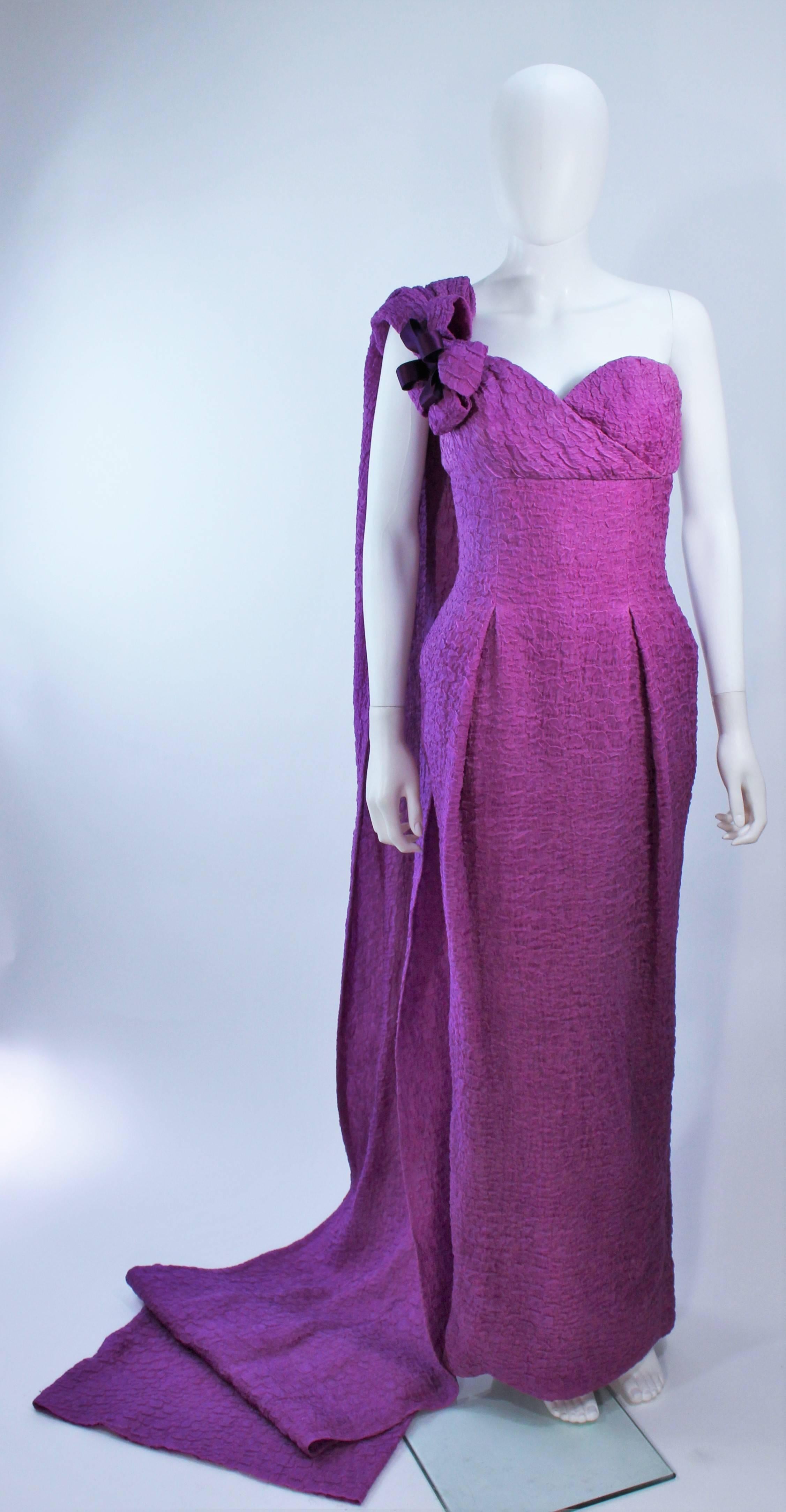 This is a long purple gown by Christian Dior Haute Couture, from 1988. It is made of a crinkled chiffon, with a fitted bustier, flower, and a long shoulder wrap. In excellent vintage condition.

Provenance:  Betsy Bloomingdale

Measures
Length: