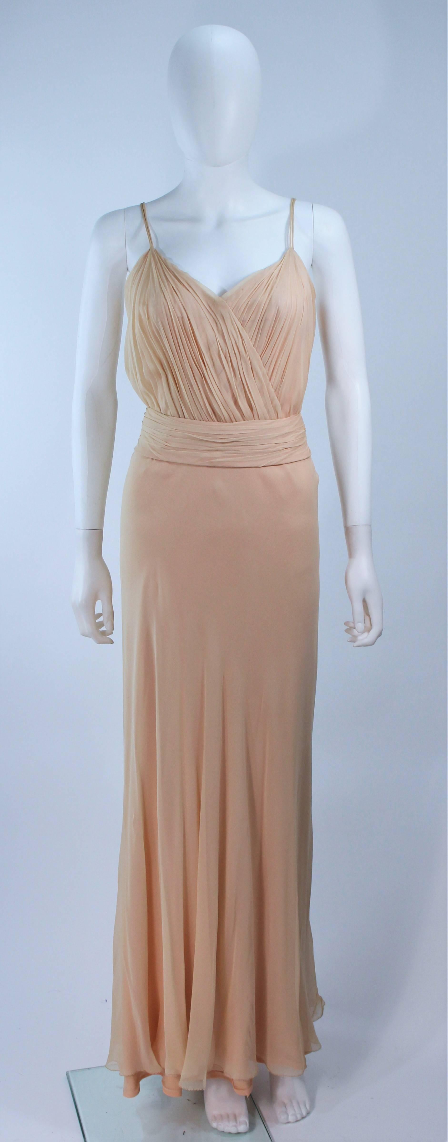 This Ceil Chapman gown is composed of a nude silk chiffon. Features a draped and gathered design, with interior boning. There is a center back zipper closure and belt. In great vintage condition. 

  **Please cross-reference measurements for