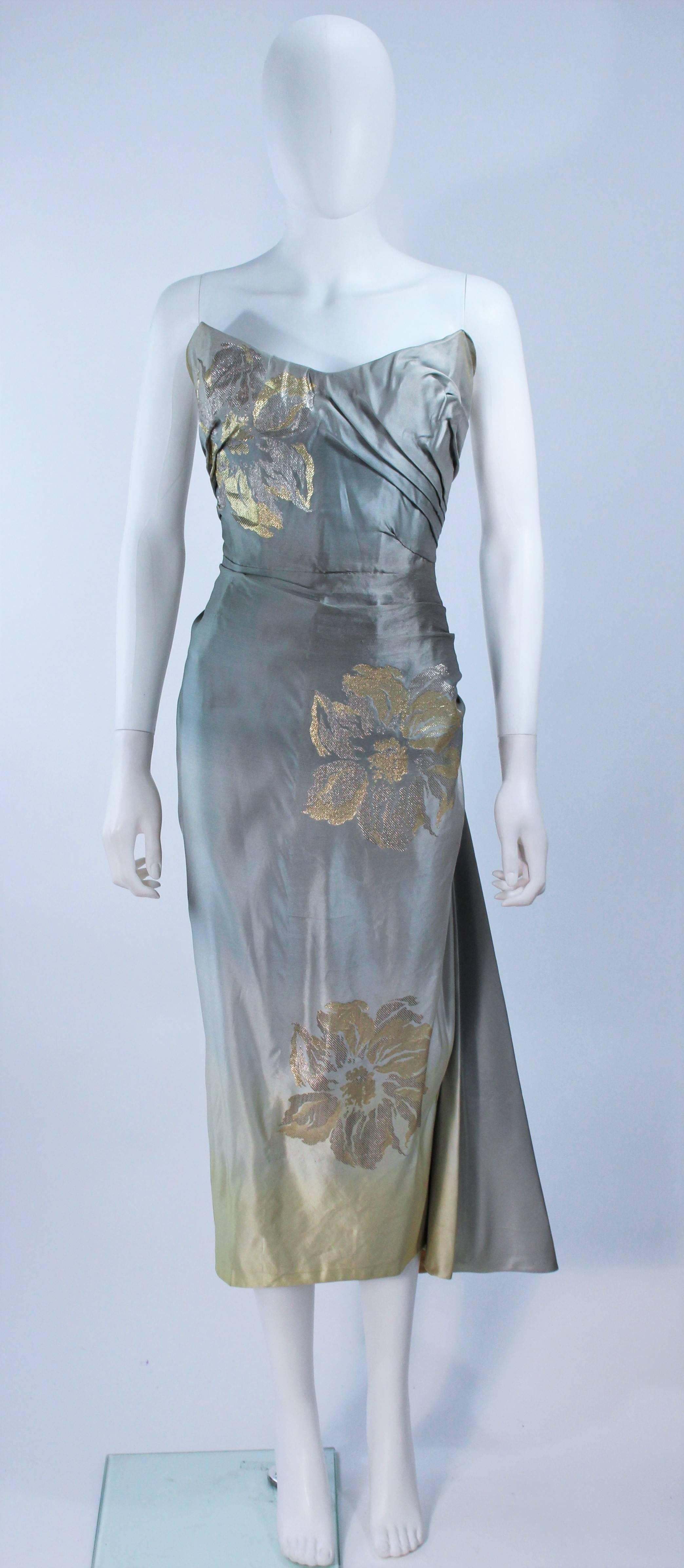  This gown is composed of a gradient silk, which goes from pale blue to light yellow, with a floral pattern. Features a center back closure, with a side drape. There is an interior bustier with boning. In great vintage condition, excellent for