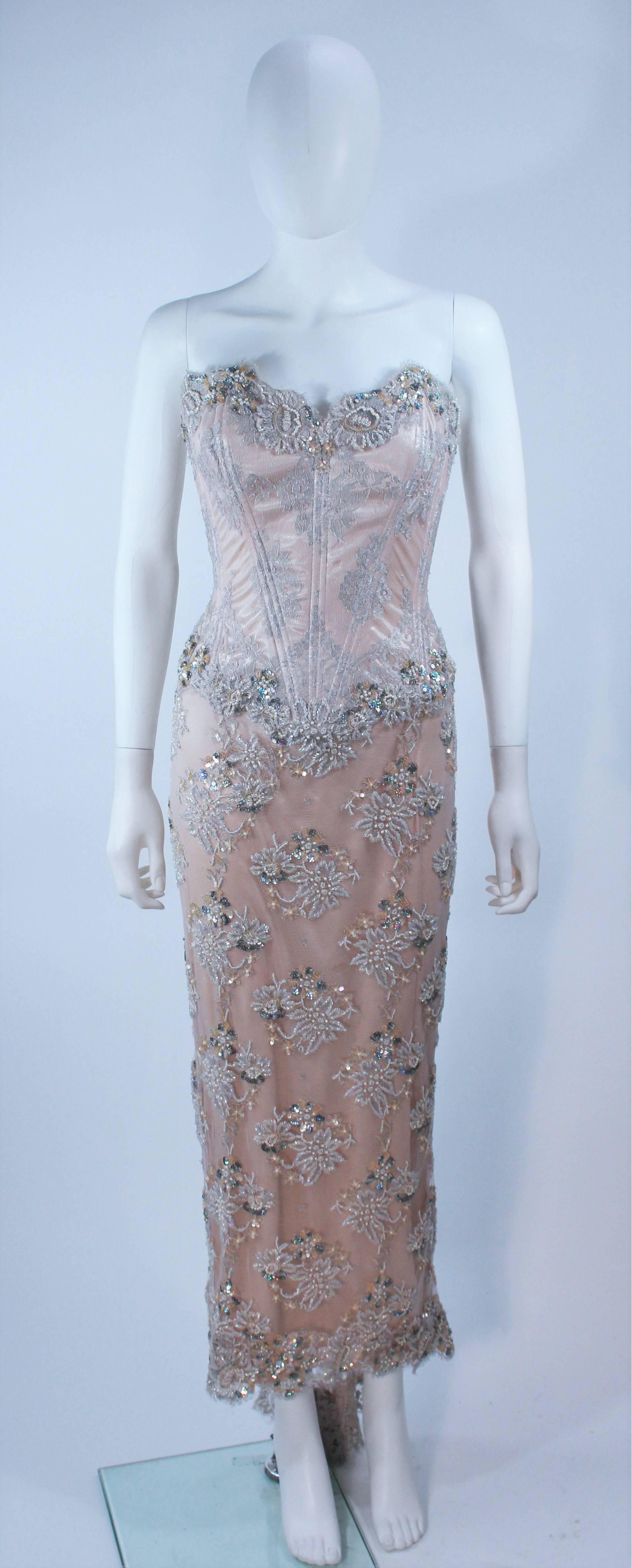 This Vicky Tiel  gown is composed of a beaded lace and silk in a blush hue. Features a boned corset upper and draped skirt. There is a center back zipper closure. In excellent condition.

  **Please cross-reference measurements for personal
